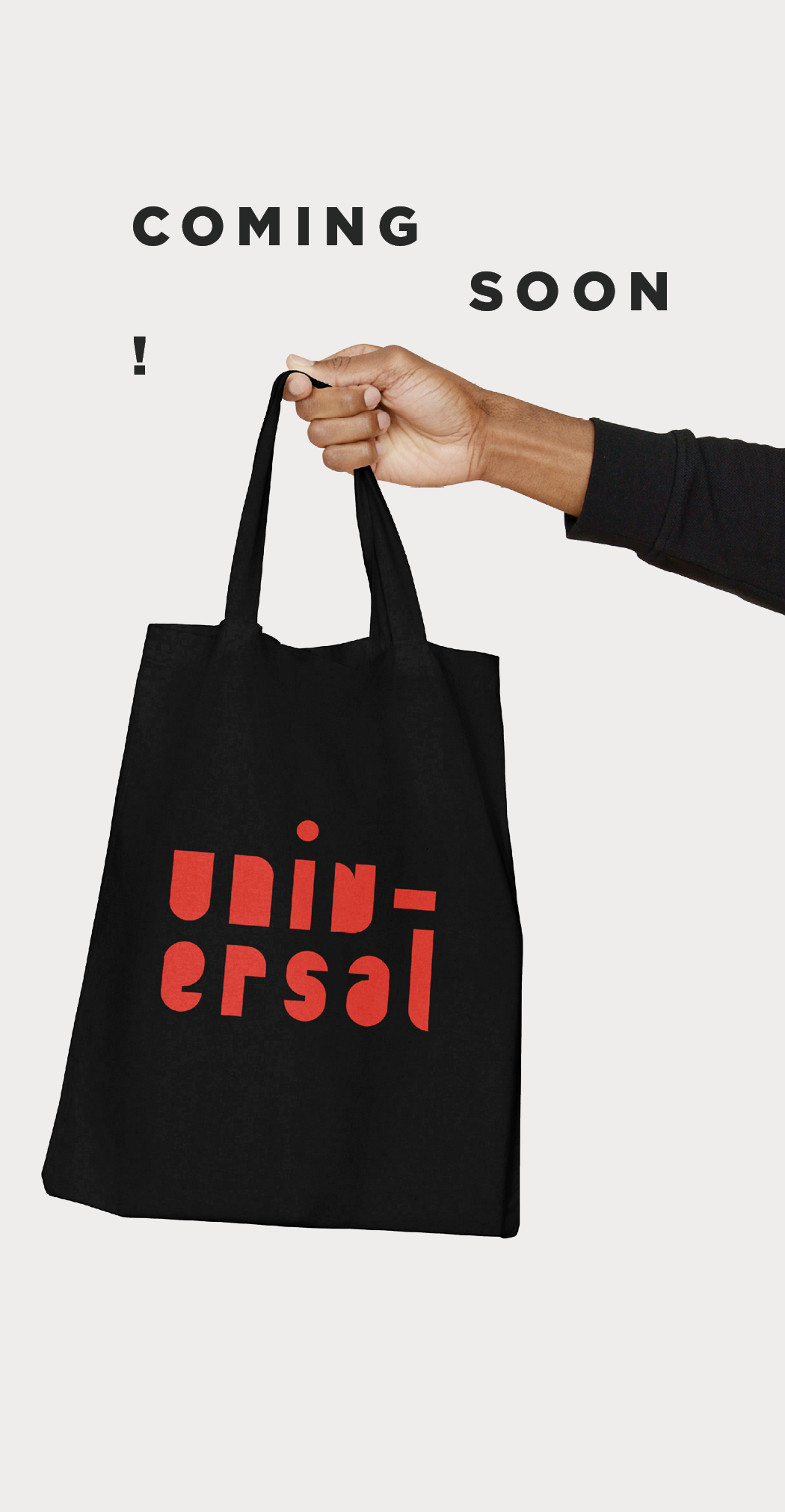 Image of a man's hand holding a black tote bag with the word, Universal, printed on the tote in red. Words above the hand read "Coming Soon!"