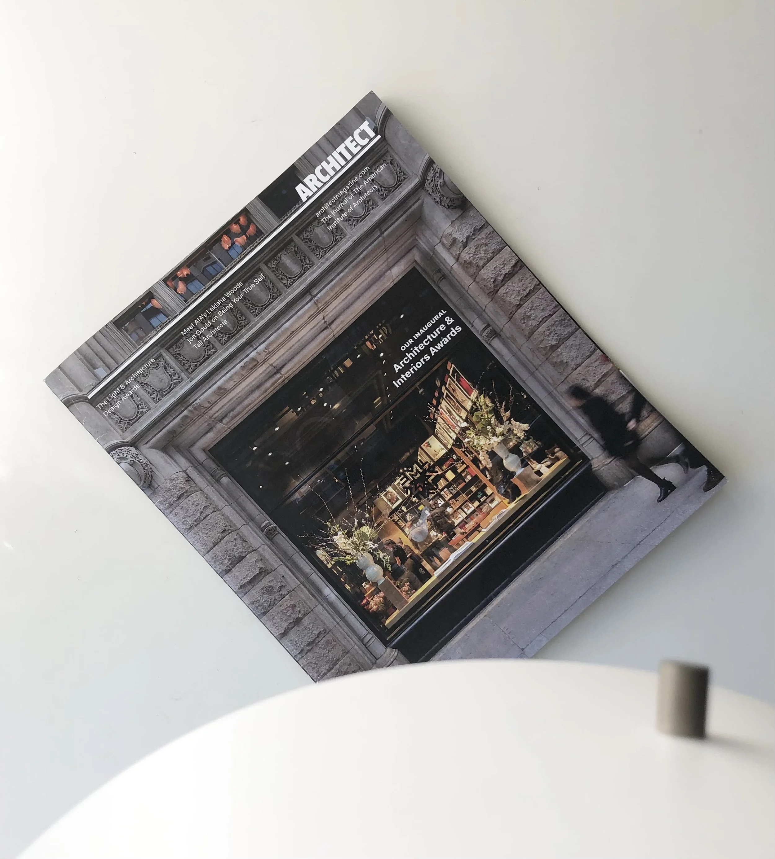 Image of the cover of Architect Magazine featuring a close up of the Fotografiska exhibit space in NYC, looking in through the large outside window.
