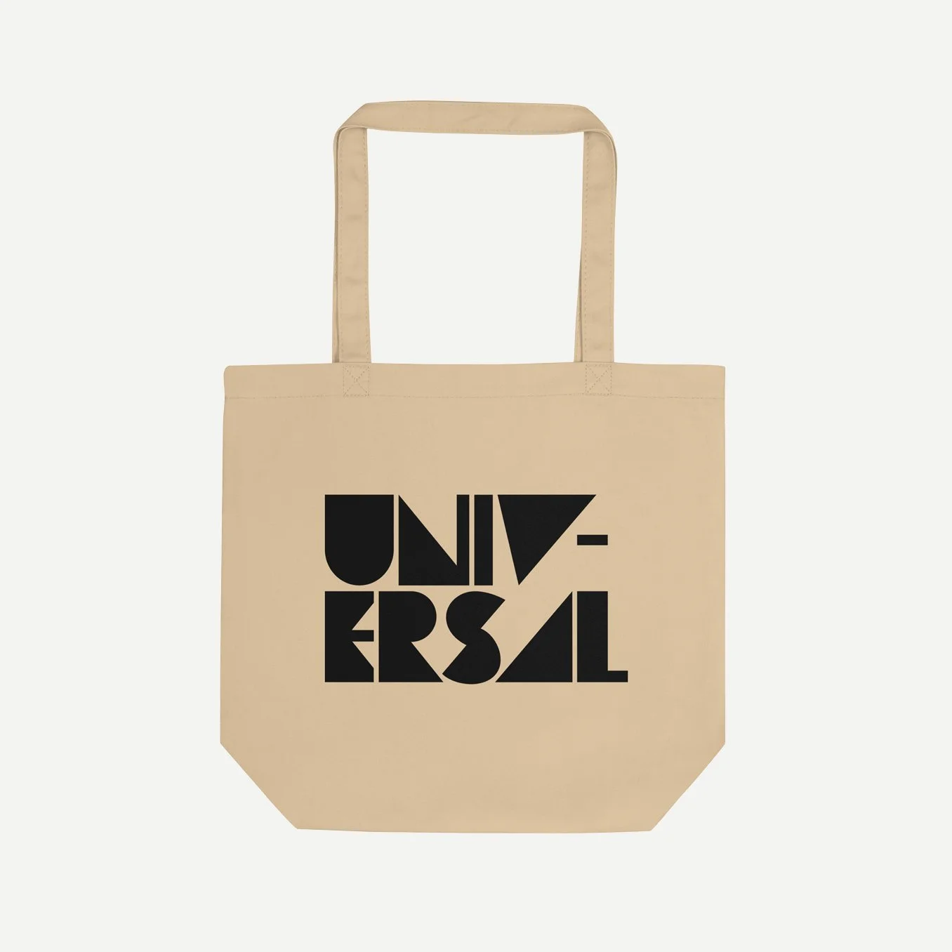 Beige colored tote bag with the word, Universal written in black across the front in a block font. The tote is on a light gray background.