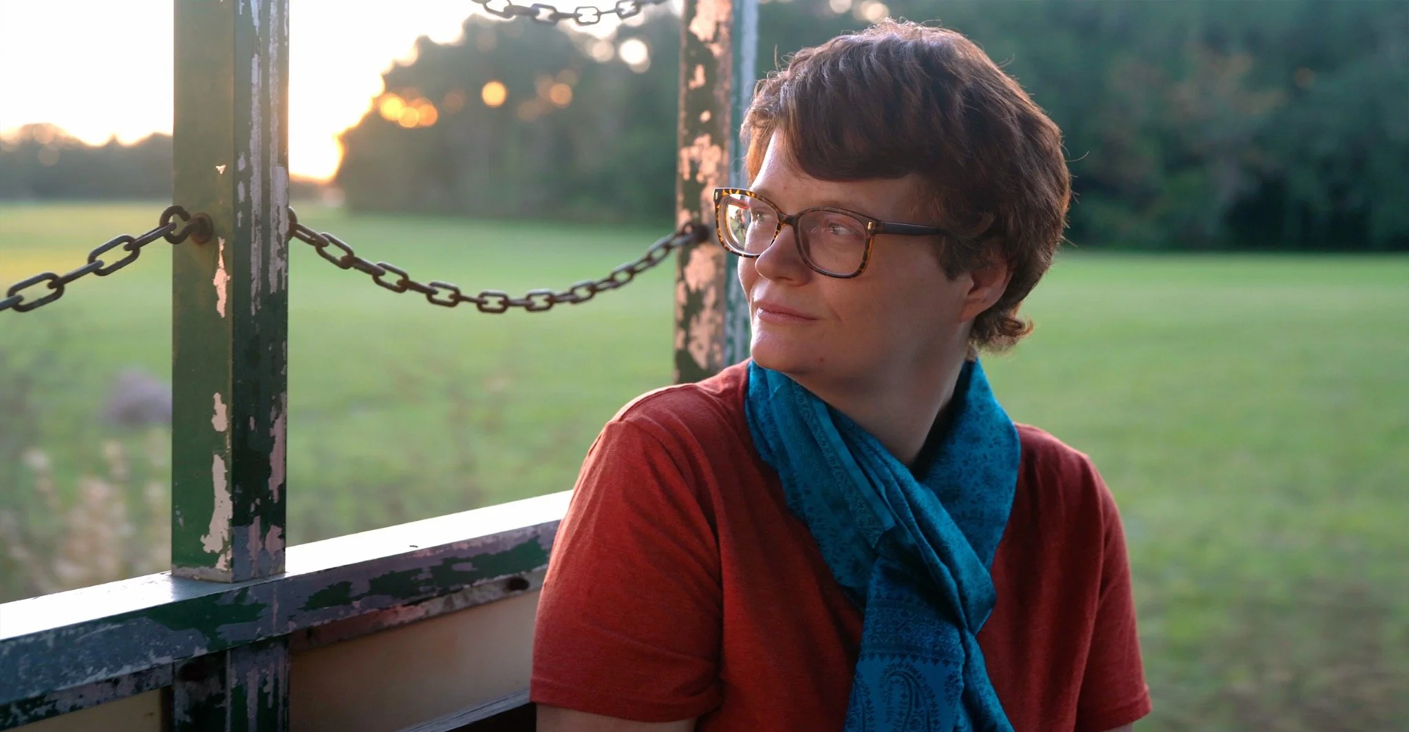 Portrait of Michelle looking into the distance outdoors in warm evening light.