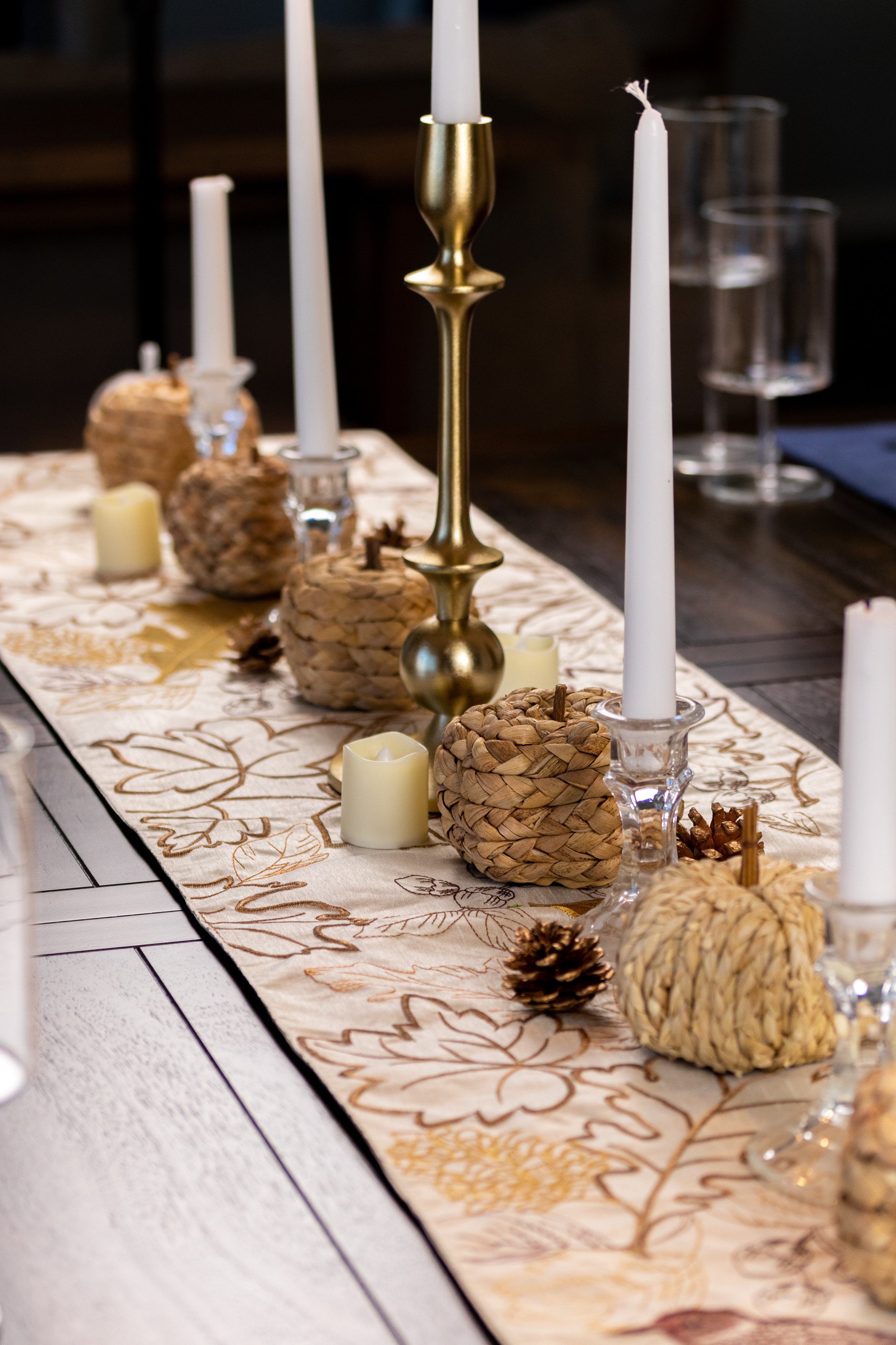a natural minimalist thanksgiving tablescape with a dark farmhouse dining table and a neutral table runner