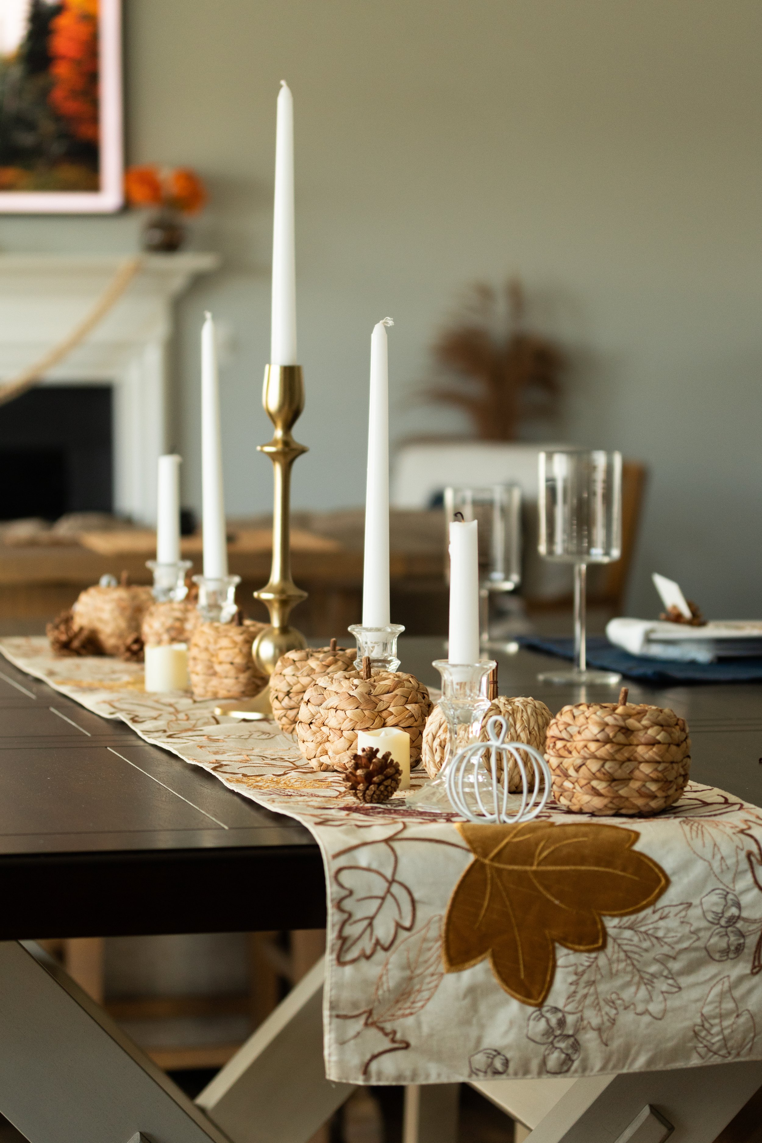 candlesticks on a brown cream table runner on a dark farmhouse dining room table