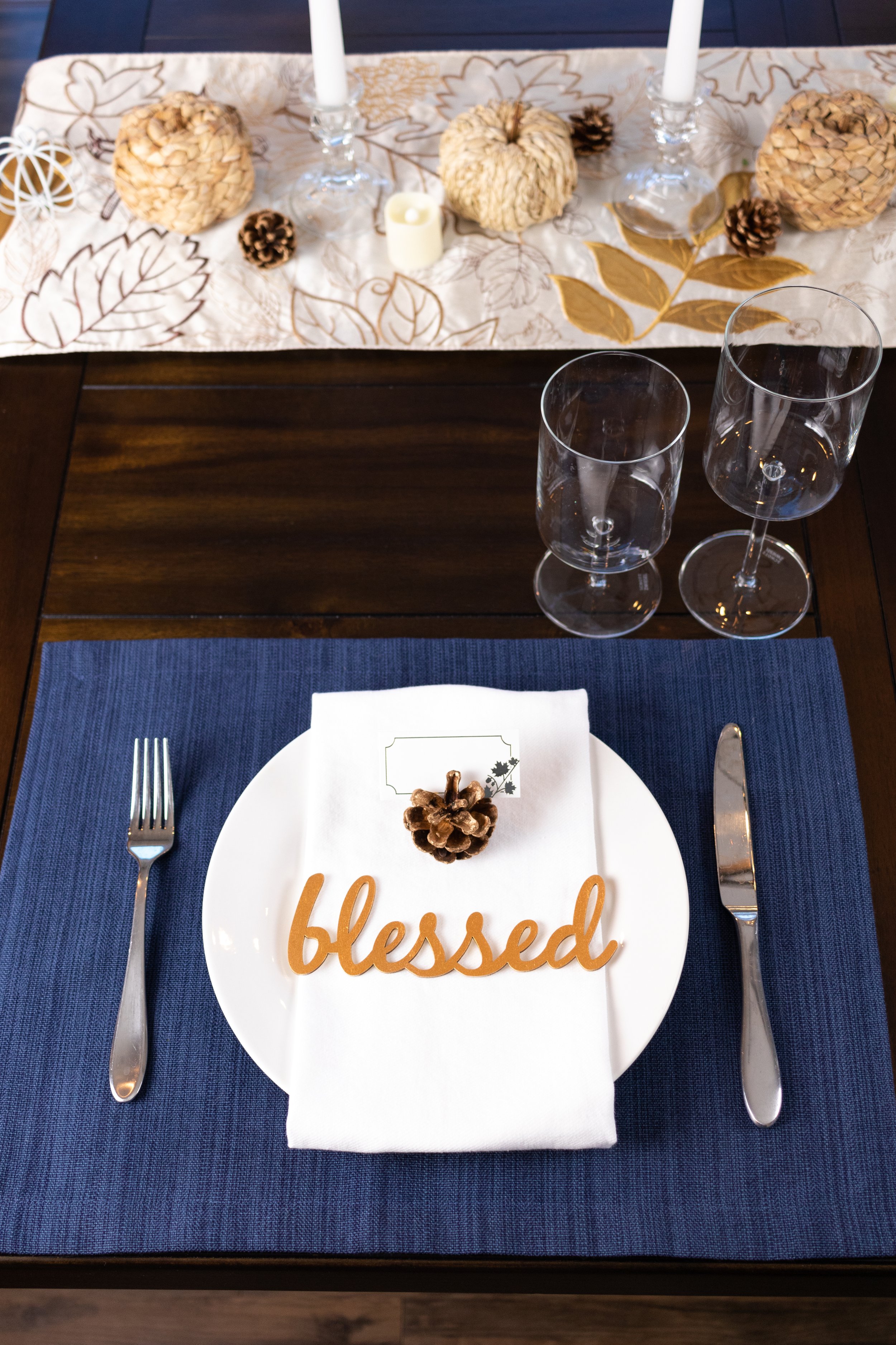 amazon white cloth napkin over a white plate on a blue target placement, thanksgiving table place setting