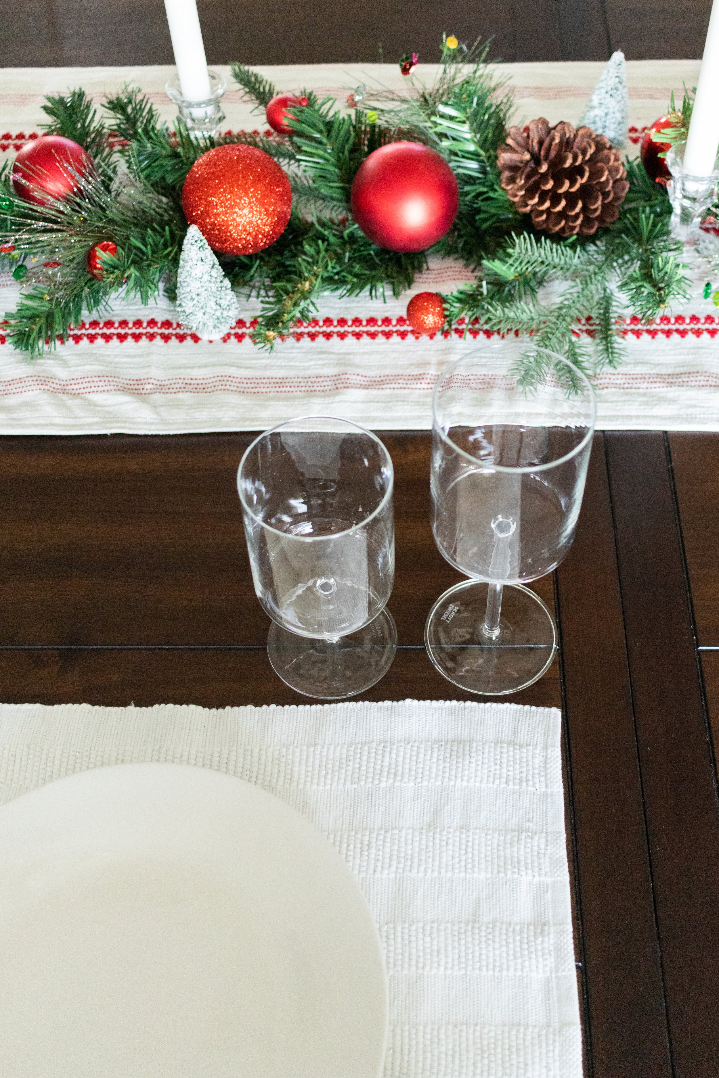 farmhouse wooden dining room table with white placemats for simple table decorations  and zwiesel wine glasses