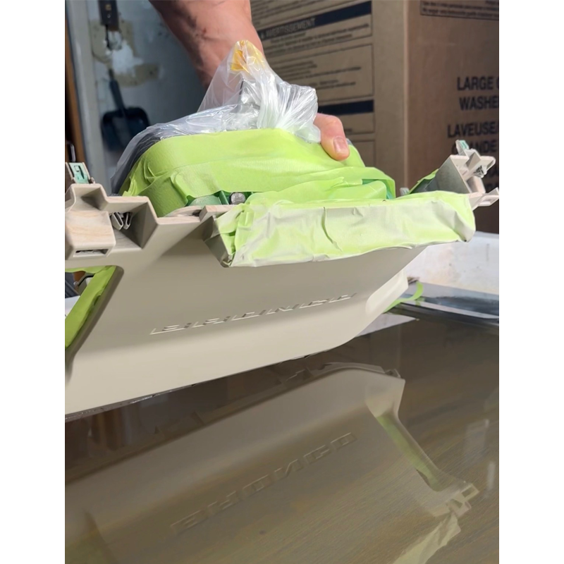 A man hydrodipping a Ford Bronco dashboard for a famous fashion designer Stacey Bendet