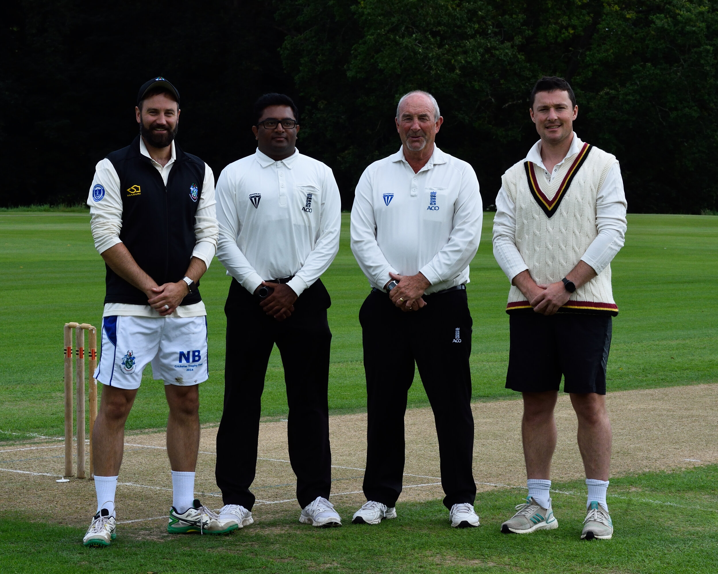 Nick Brothers and Greg Smith with umpires Vinoj Srinivasan and David Gower