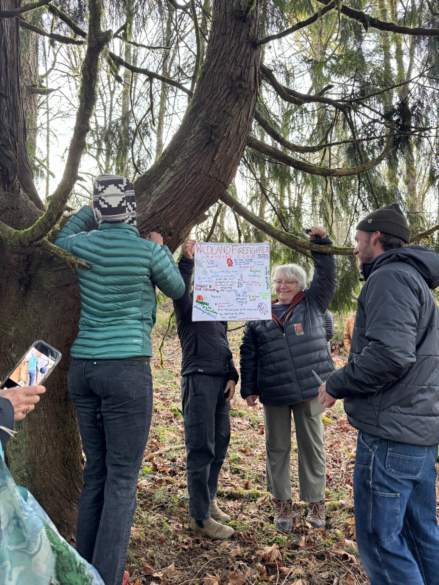Hanging a group-made large prayer flag in the forest