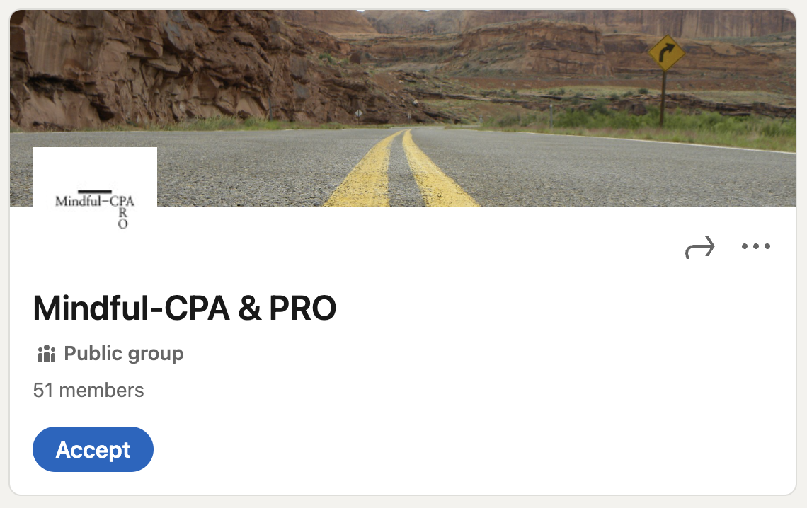 A desert landscape with rugged cliffs in the background and a two-lane road with yellow dividing lines, and a yellow warning sign indicating a right turn.