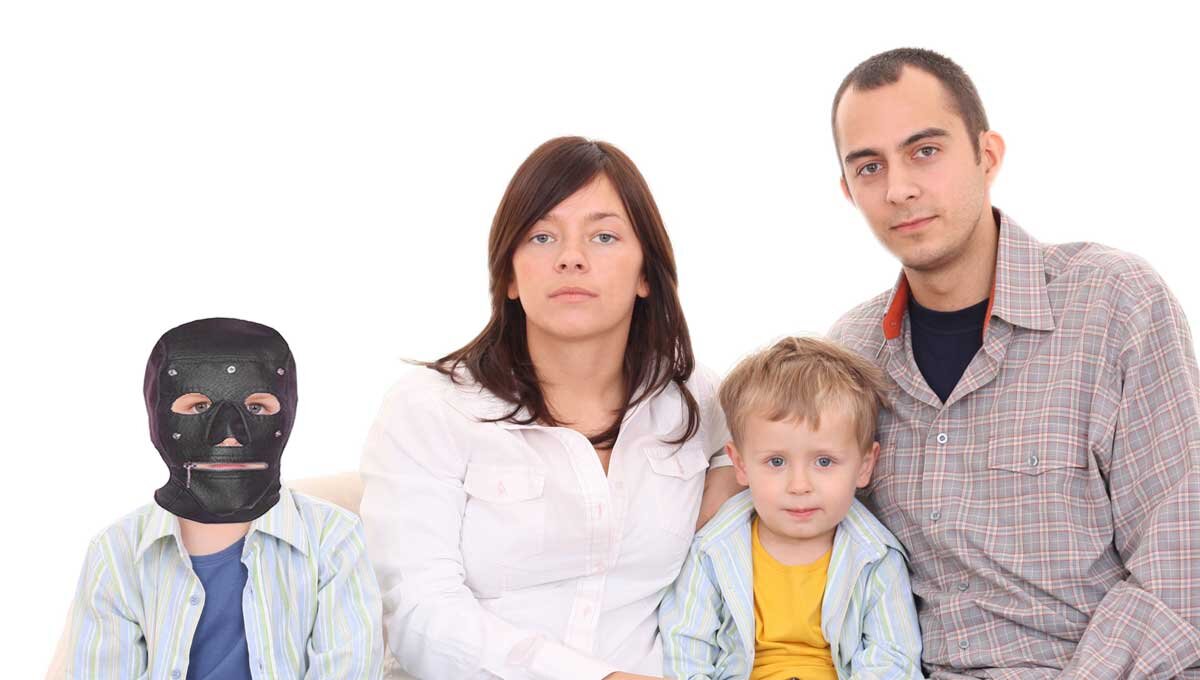 Loving parents with their child before his first day of school with his anti-virus mask