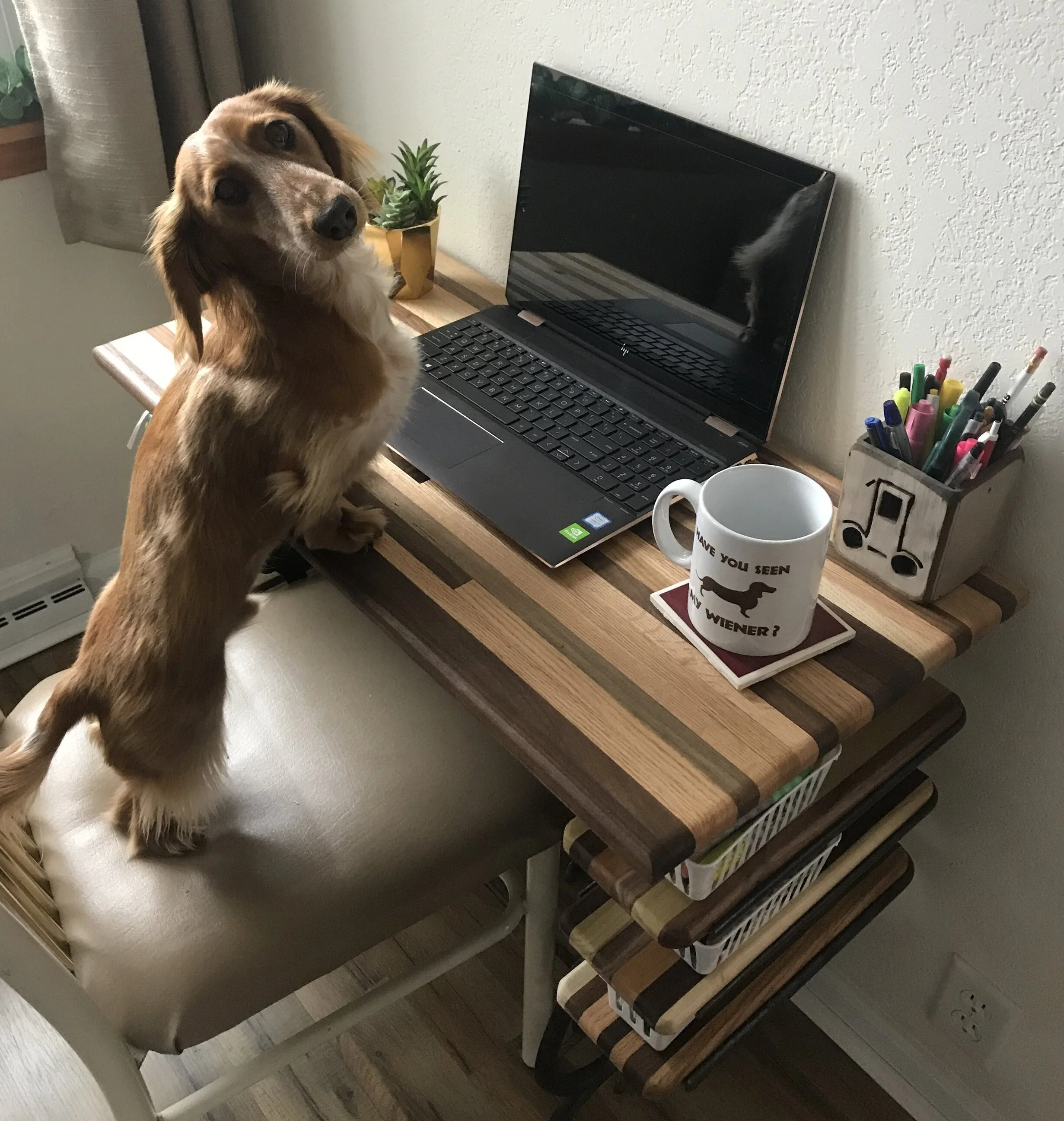  Hudson working at a butcher block style top table built on a Singer sewing machine base 