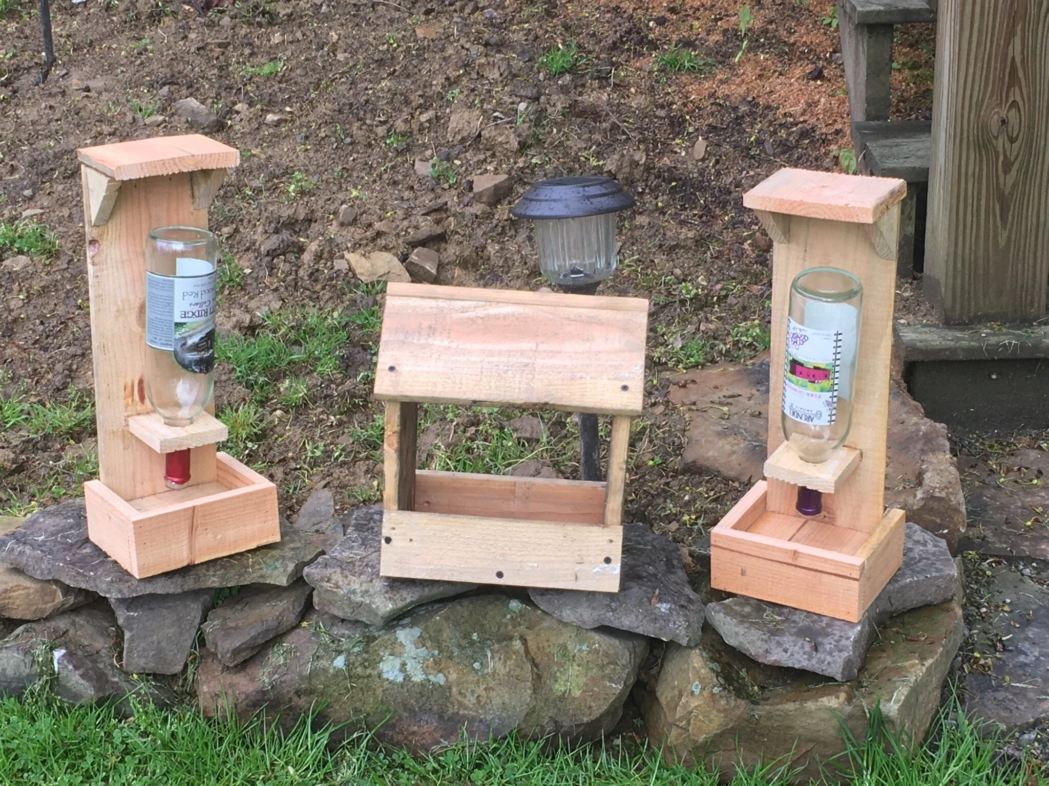  Bird feeders for the yard made out of reclaimed pallet wood &amp; glass wine bottles 