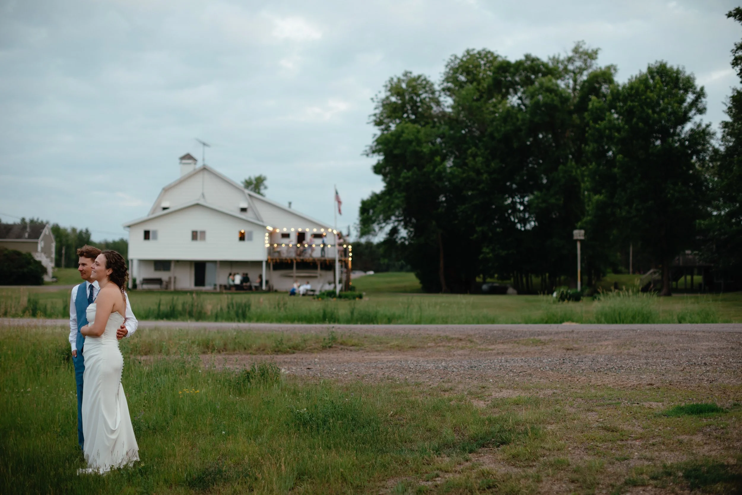 Bride and groom standing in front of their Minnesota barn wedding venue