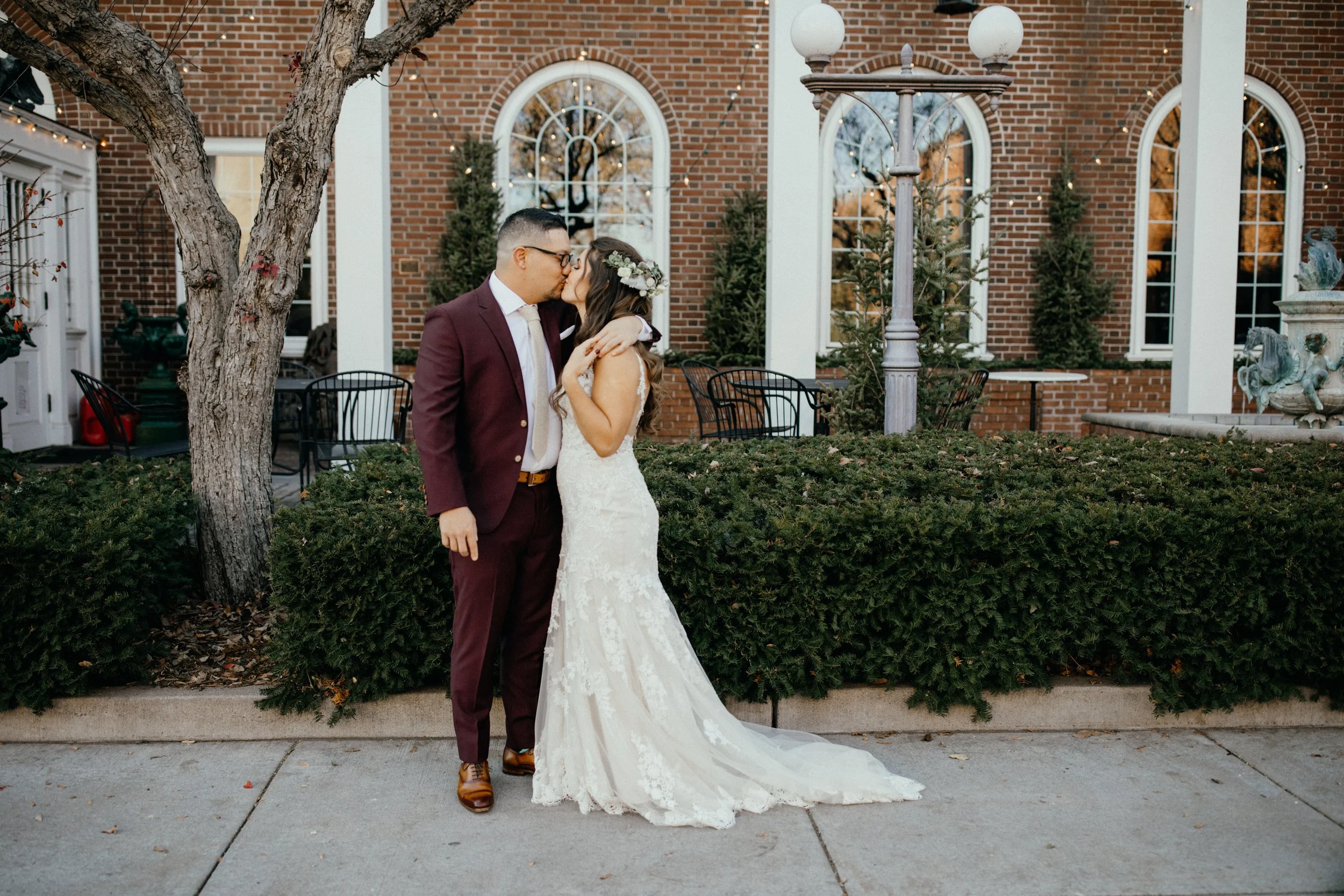 Bride and groom kissing outside the Lowell Inn in Stillwater, Minnesota