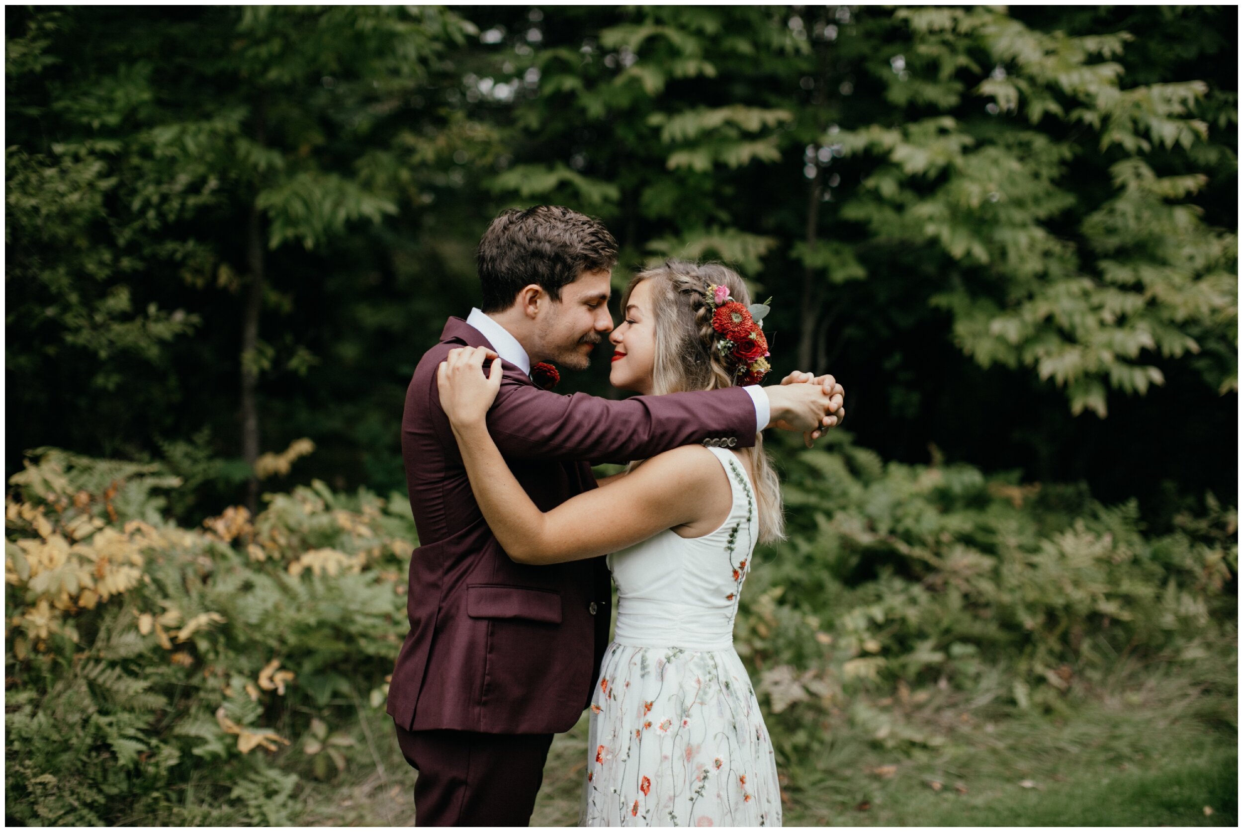 Bride and groom hugging and touching noses at Minnesota summer wedding at Camp Warren