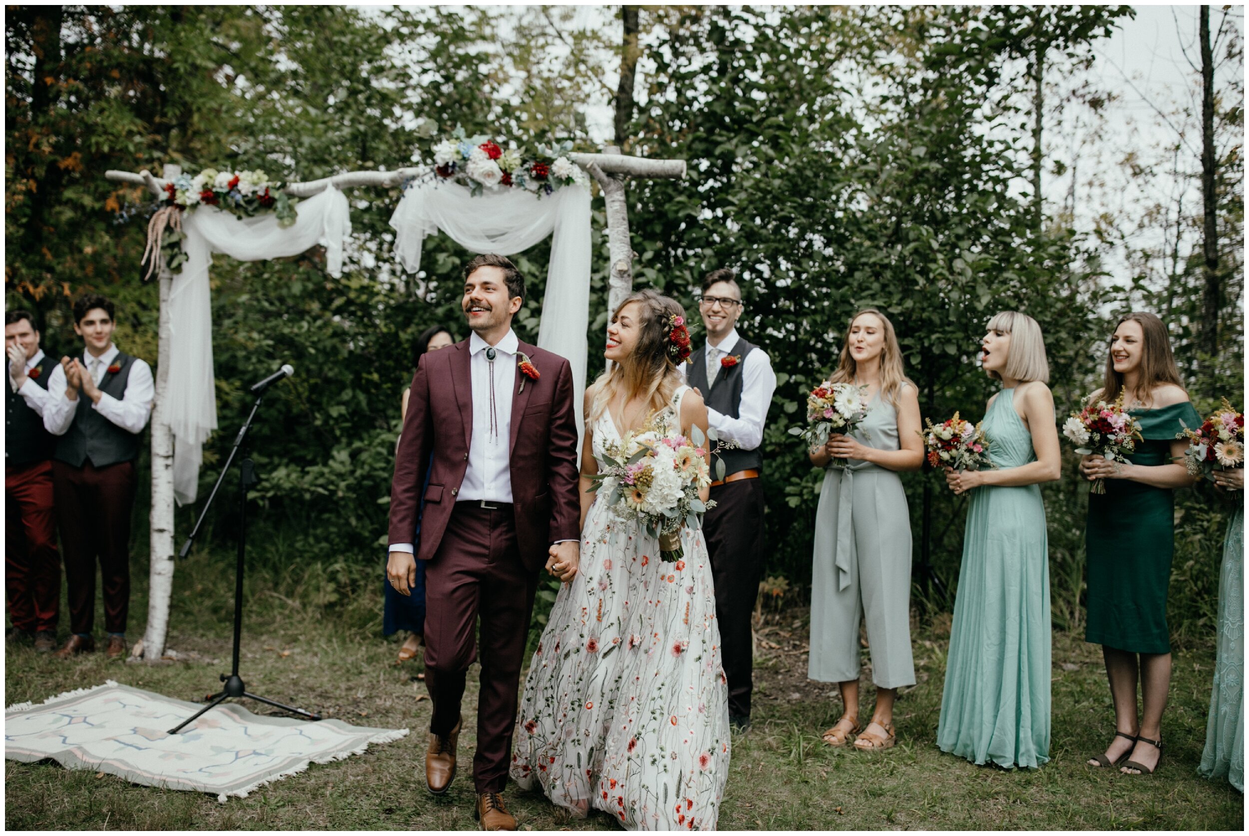 Happy bride and groom after whimsical summer camp wedding in northern Minnesota