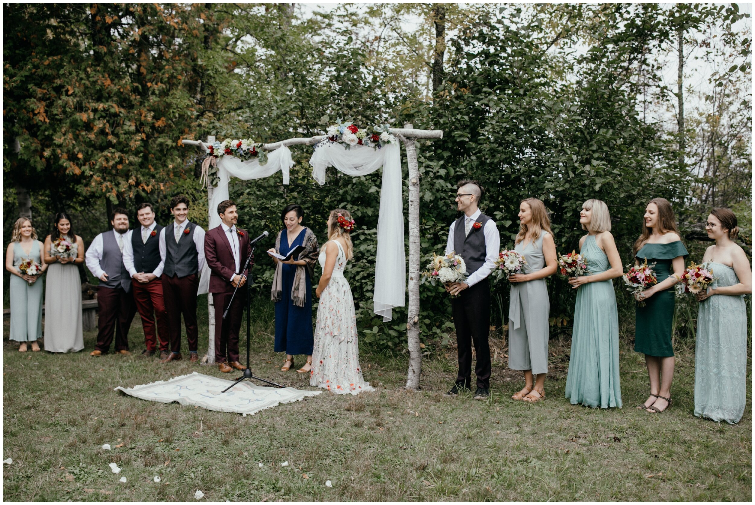 Boho summer camp wedding ceremony on half moon lake in northern Minnesota