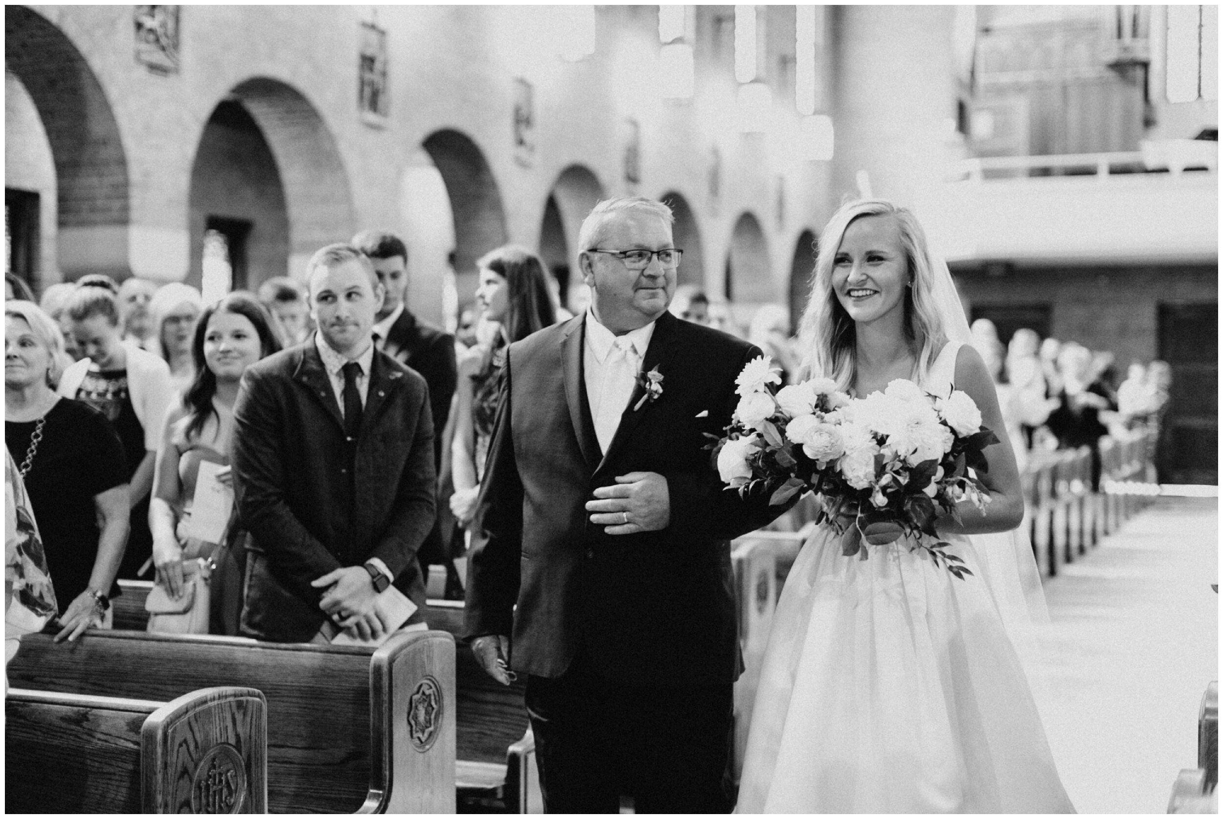 Father and bride walking down aisle during wedding ceremony in Brainerd, Minnesota