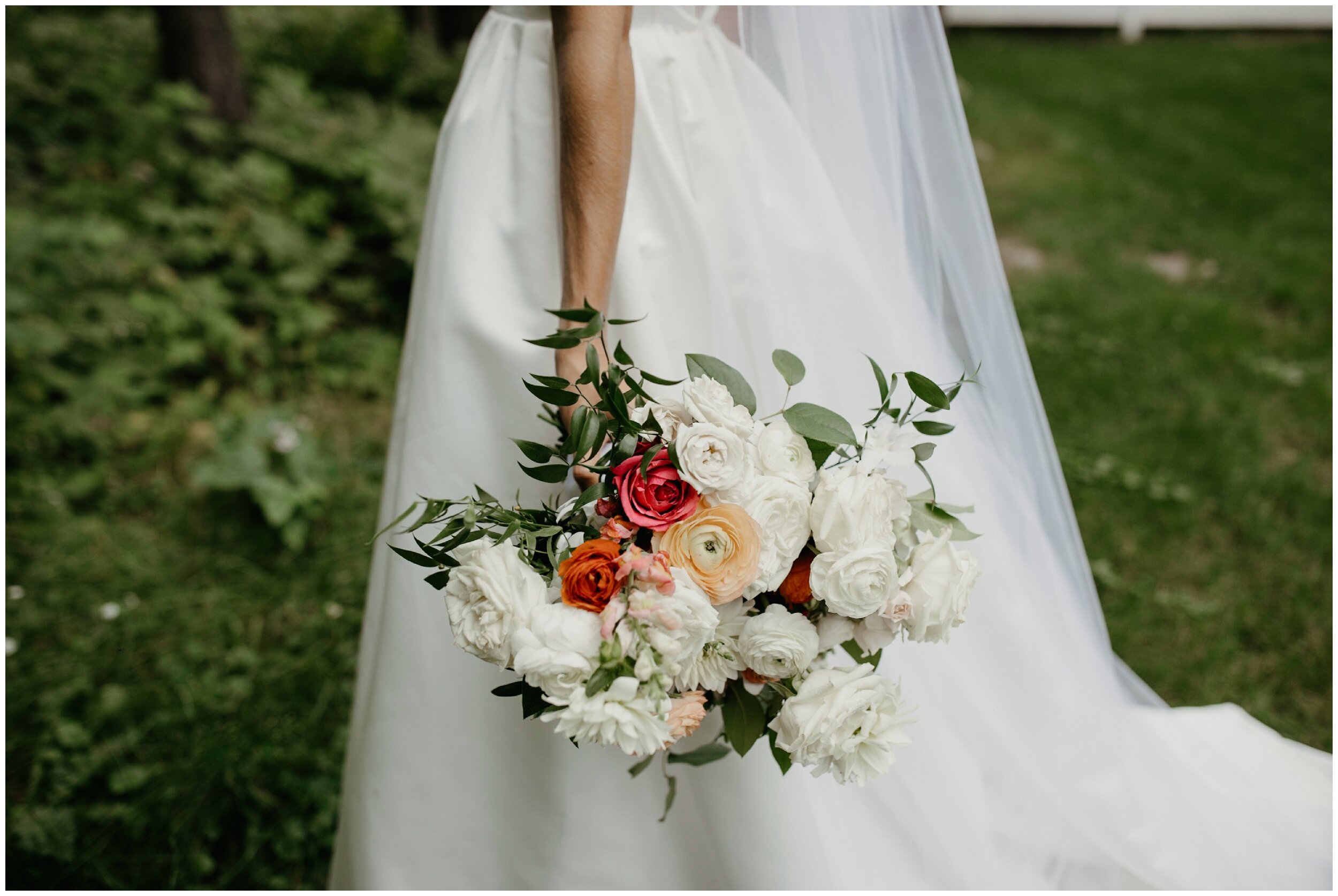 Bride holding bridal bouquet by Bloom Designs at Grand View Lodge 