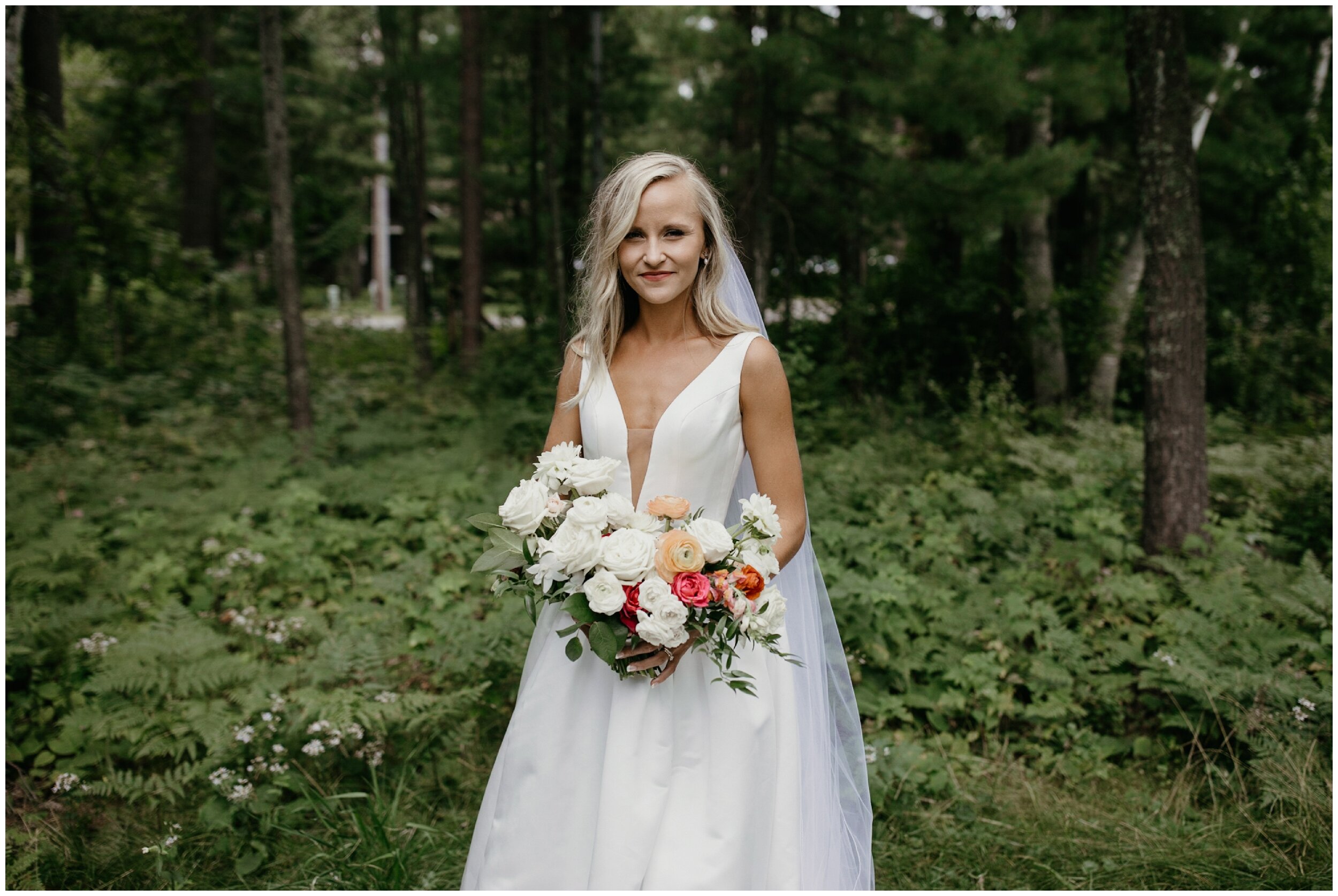 Bride standing in front of woods at Grand View Lodge wedding in Nisswa, Minnesota