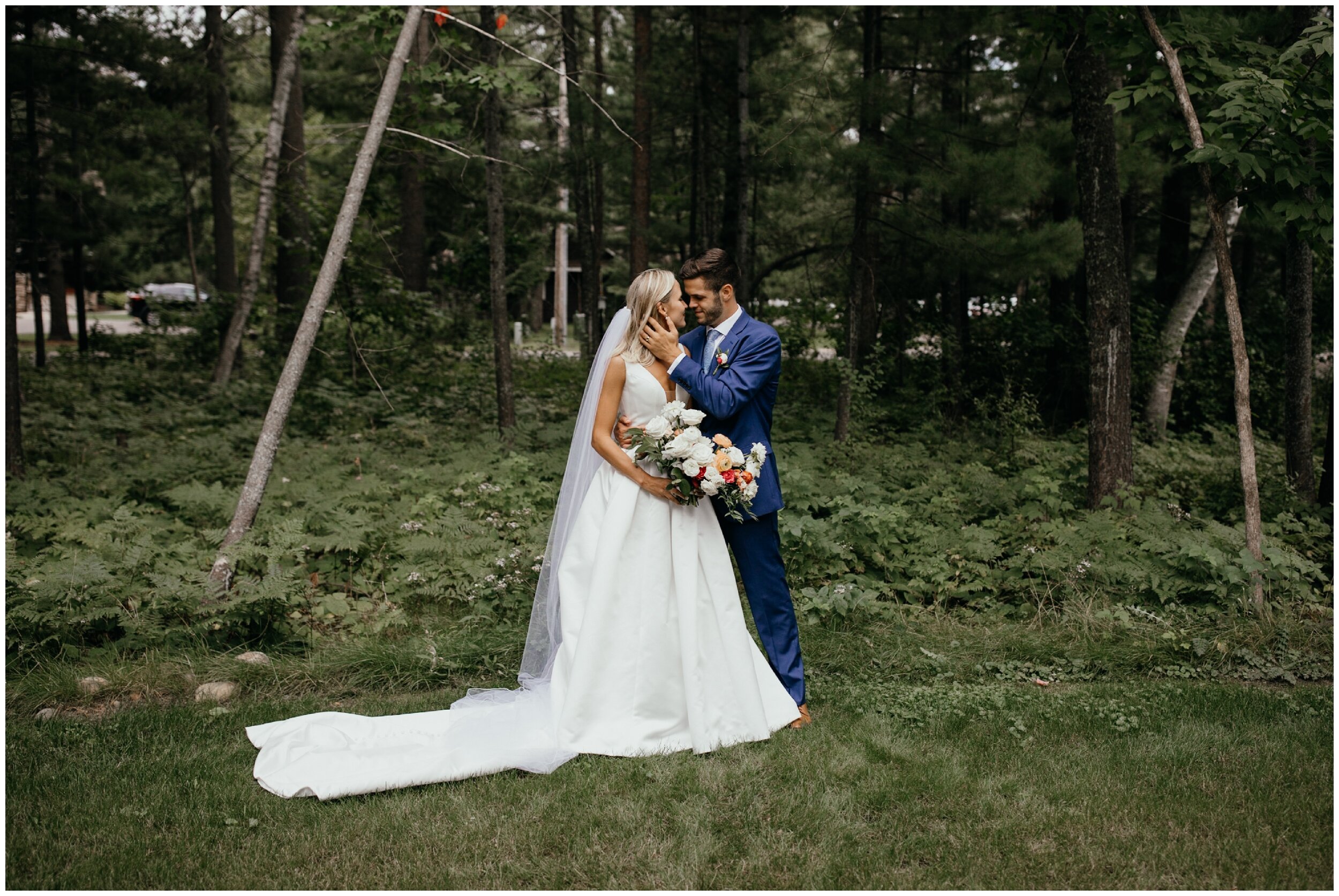 Bride and groom standing in front of woods at Grand View Lodge wedding in Nisswa, Minnesota