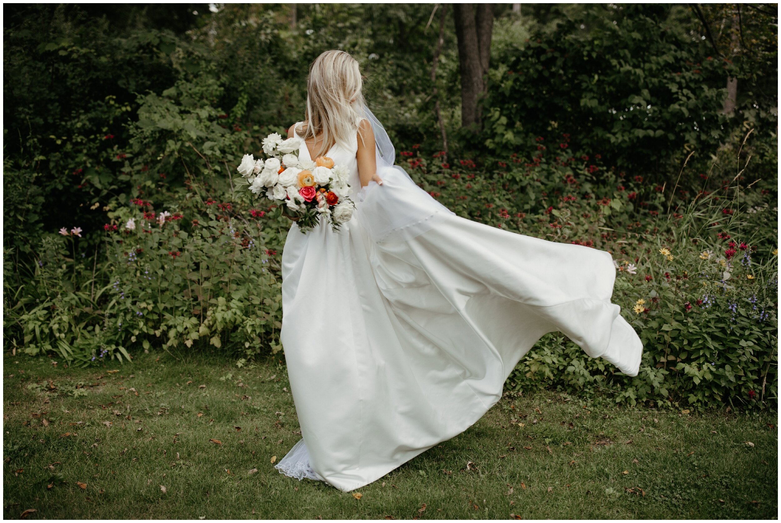 Bride's ballgown wedding dress caught in the wind during luxury Minnesota wedding at Grand View Lodge