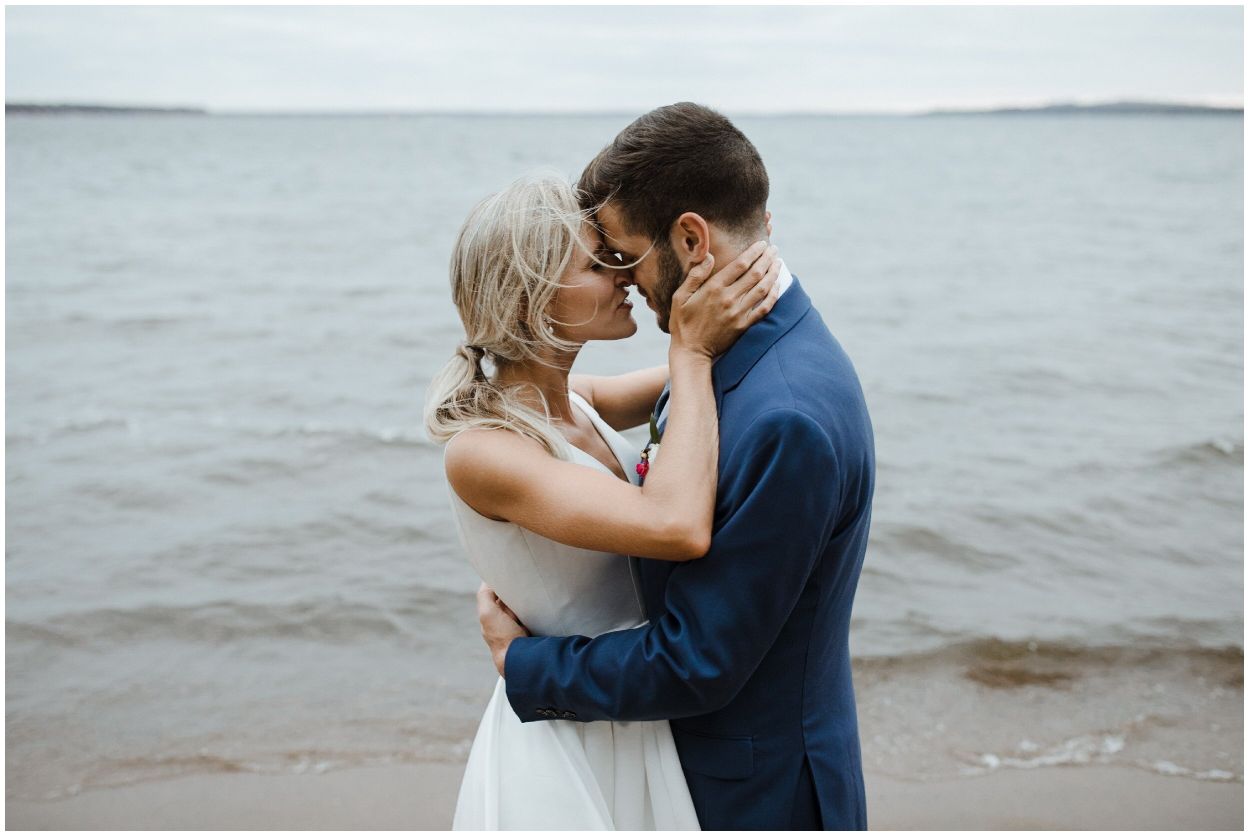 Bride and Groom kissing on beach at Grand View Lodge wedding in Nisswa Minnesota