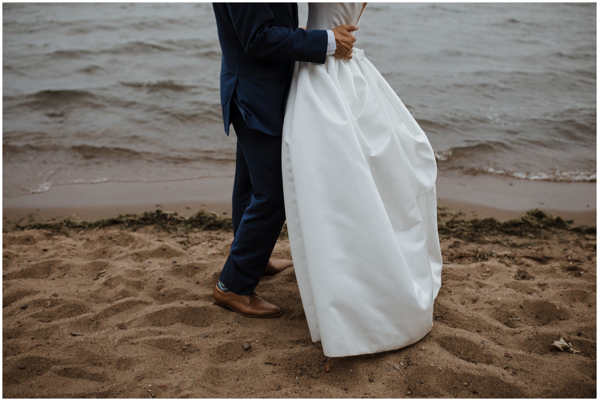 Bride and groom standing in gull lake beach at grand view lodge wedding