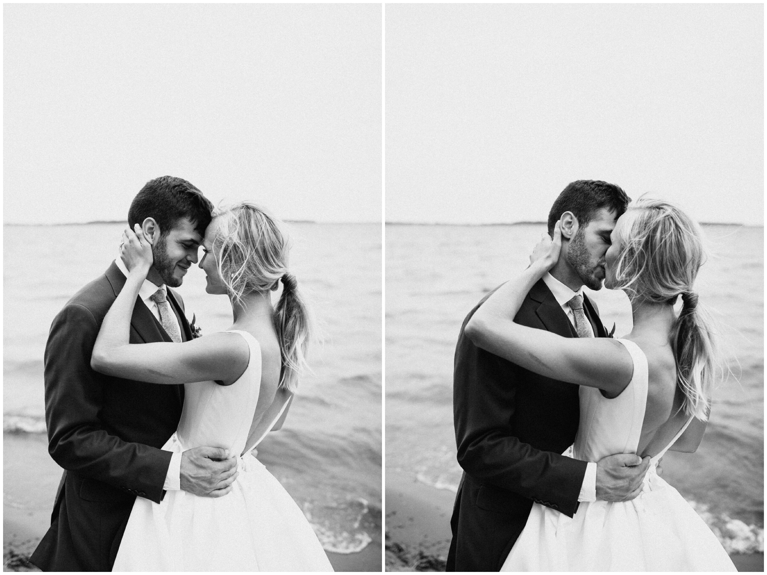 Wedding couple kissing on Gull Lake beach at Grand View Lodge in Nisswa, Minnesota