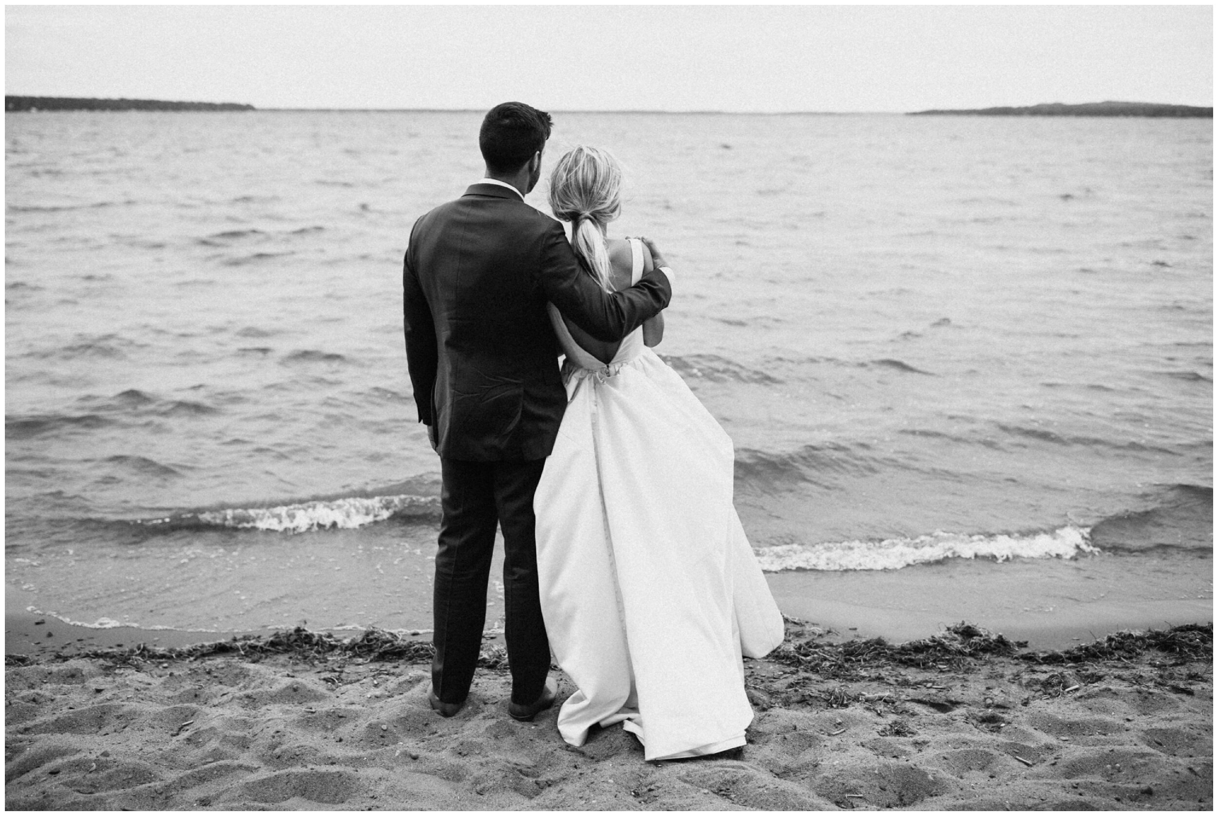 Grand View Lodge wedding couple looking out at Gull Lake 