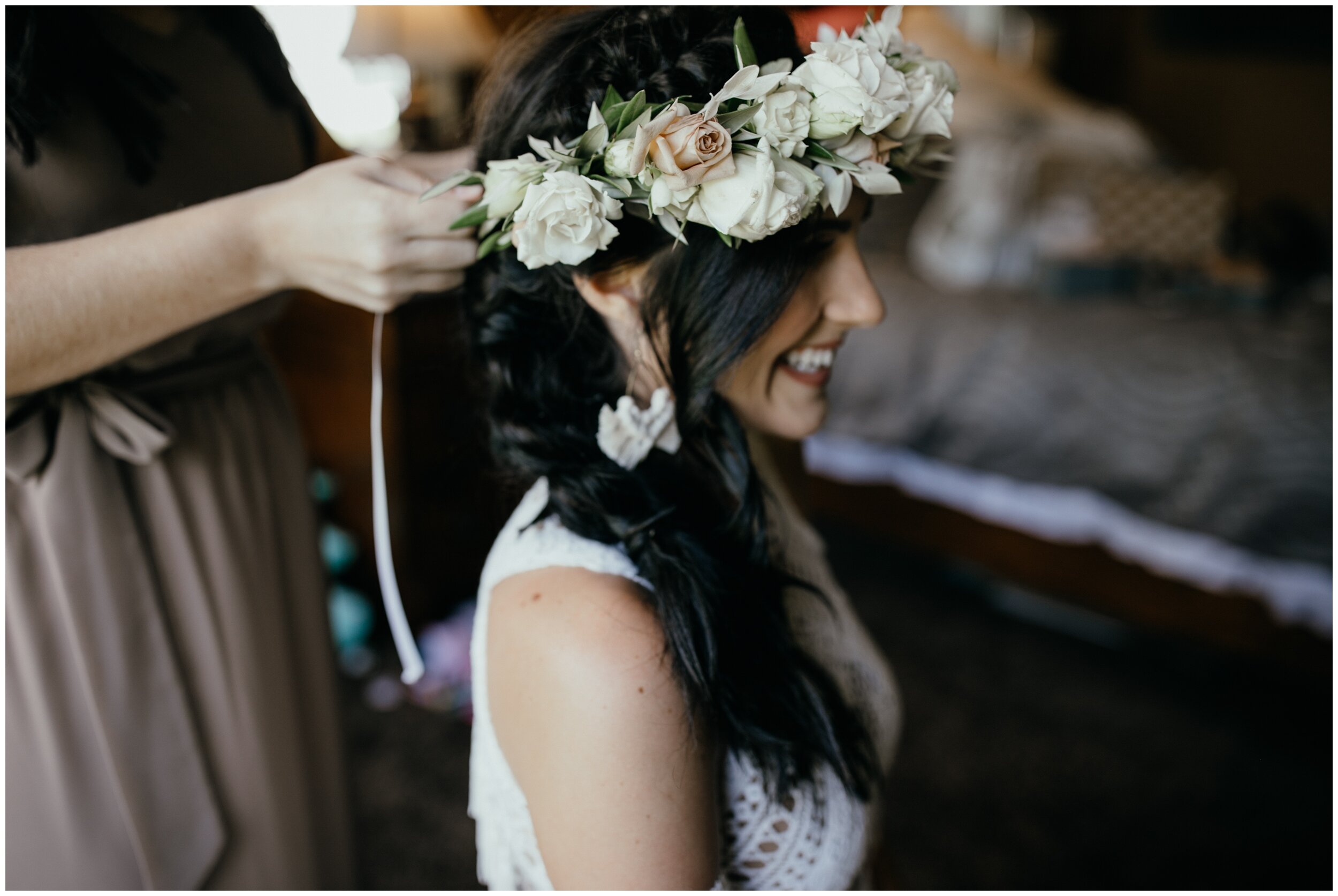Bride putting on floral crown for her Minnesota boho backyard wedding 