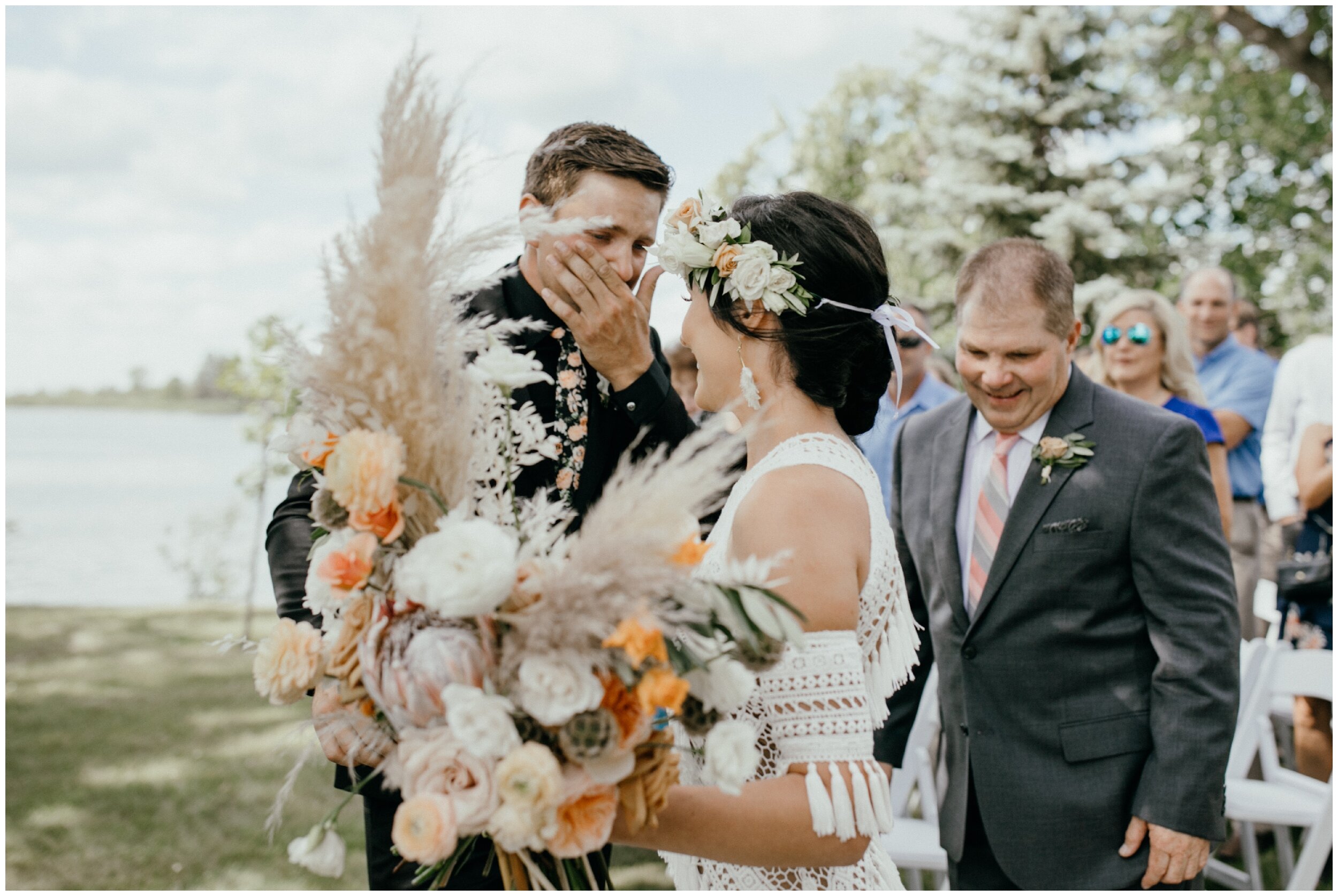 Emotional groom as bride walks down aisle at Minnesota backyard summer wedding