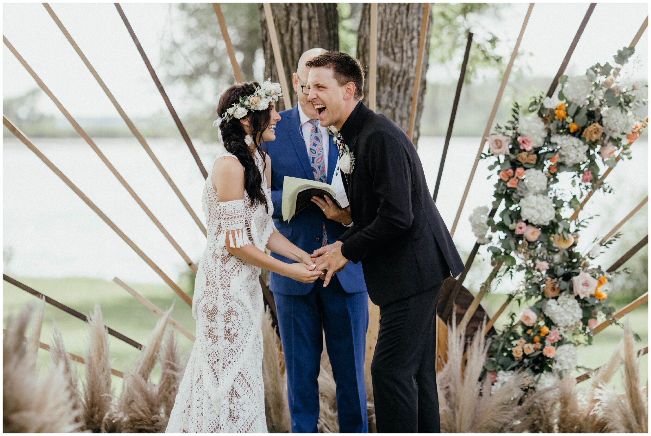 Bride and groom exchanging rings during Minnesota backyard summer wedding