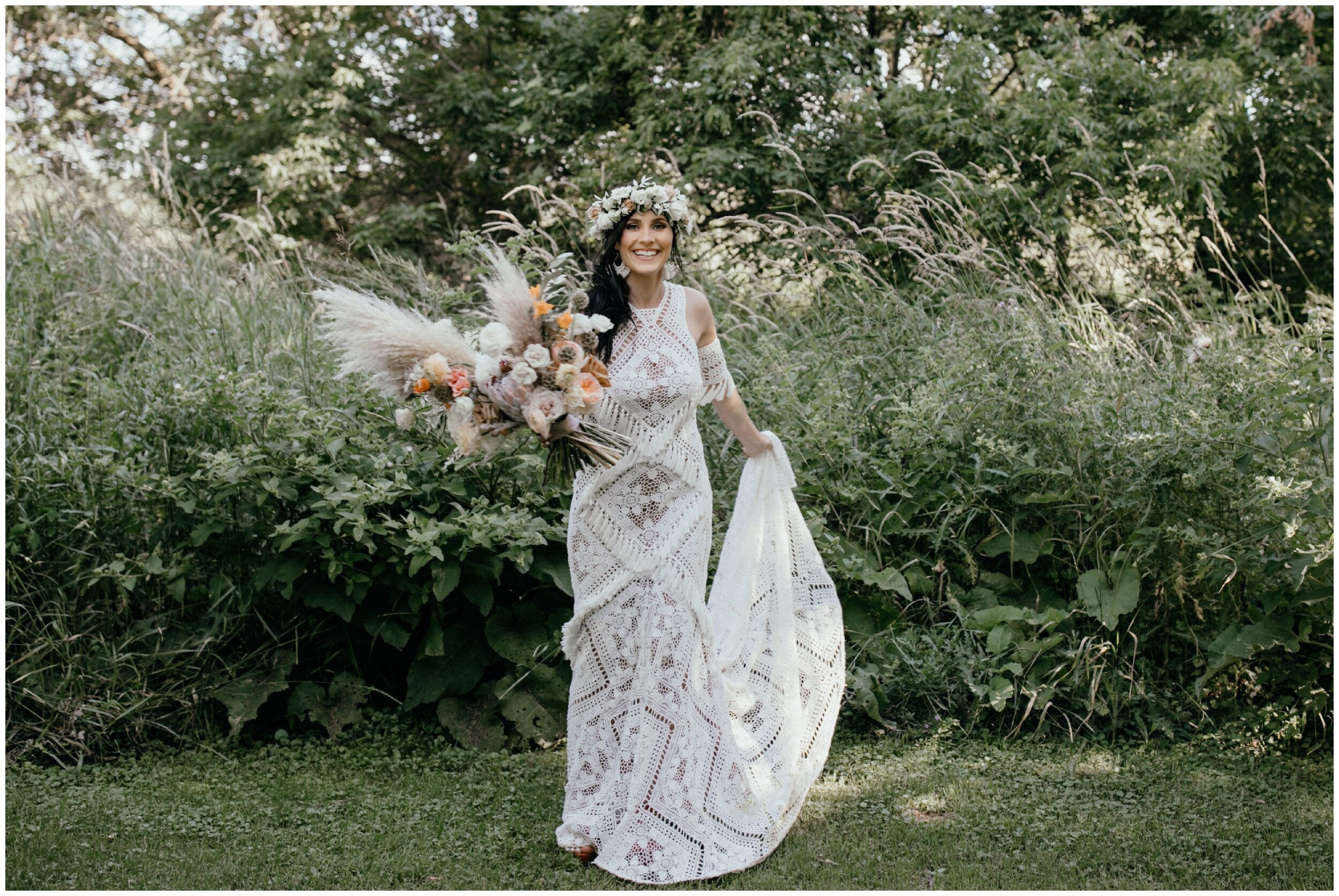 Bride standing in front of green bushes wearing floral crown, wearing a rue de seine dress at modern, boho themed Minnesota backyard wedding