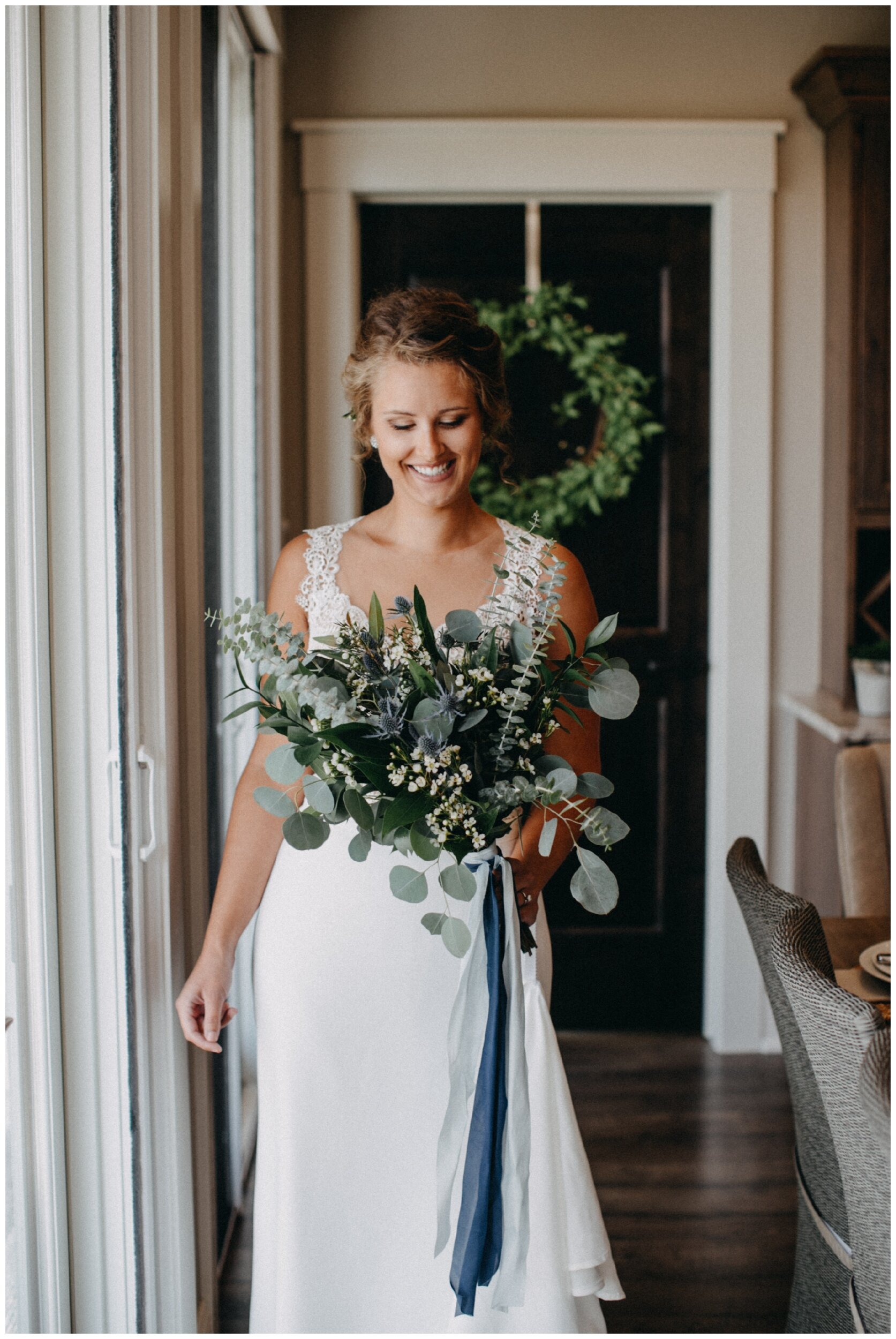 bride holding eucalyptus bouquet for Brainerd, Minnesota lakeside wedding