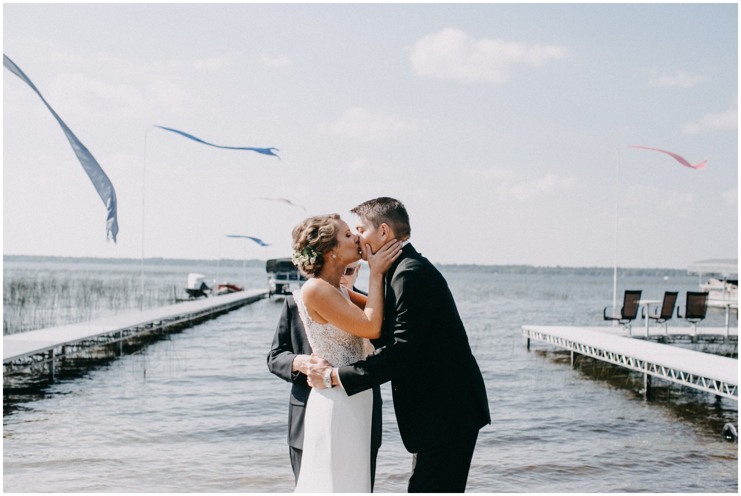 Bride and groom kiss after intimate lakeside wedding ceremony in Brainerd, Minnesota