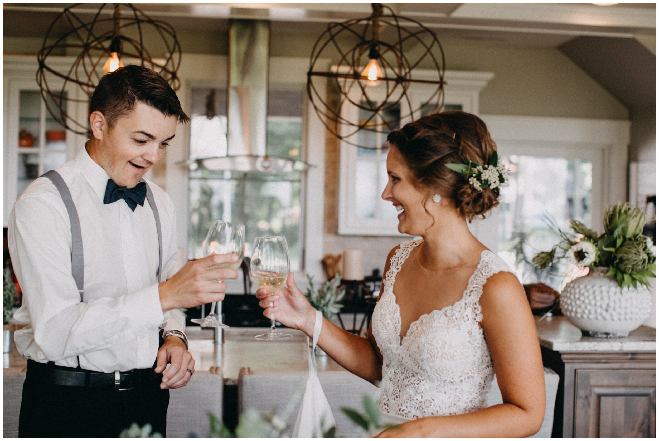 Bride and grooms cheers with champagne at Brainerd Minnesota cottage wedding