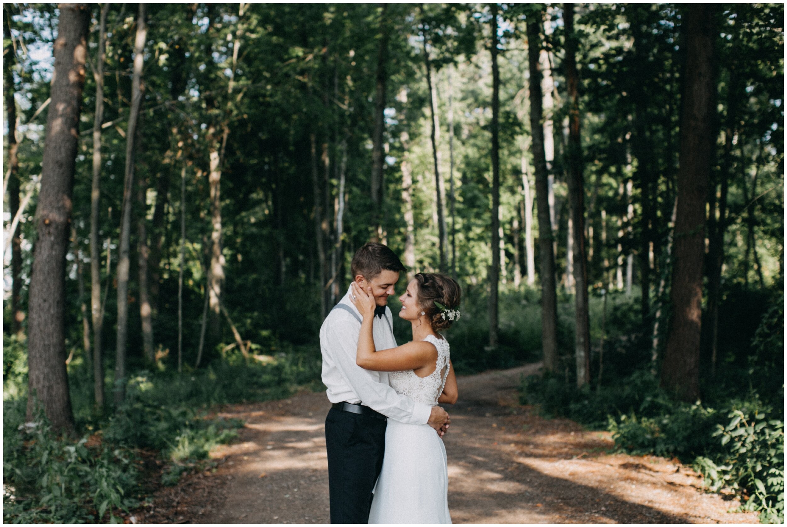 Bride and groom standing in woods at Brainerd Minnesota cabin wedding