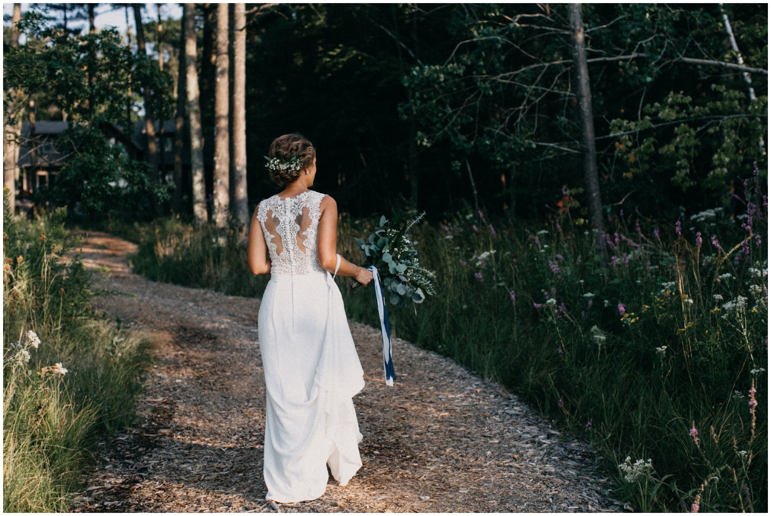Bride walking in woods at Brainerd, Minnesota cabin wedding