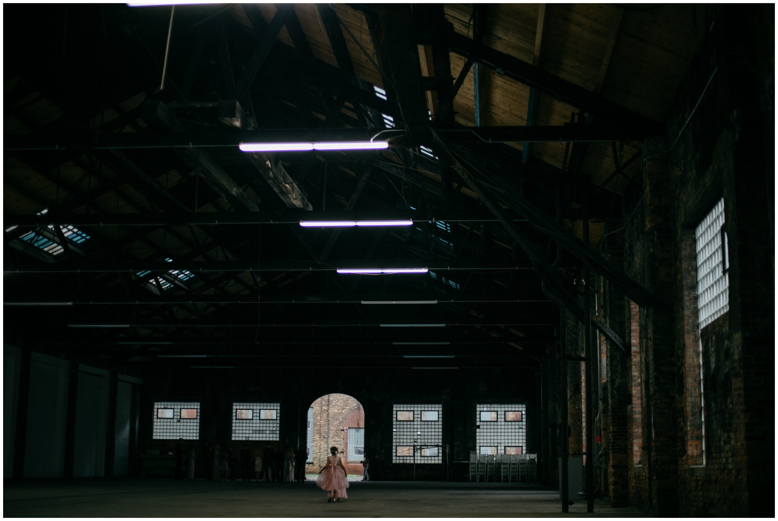 Flower girl walking inside industrial warehouse