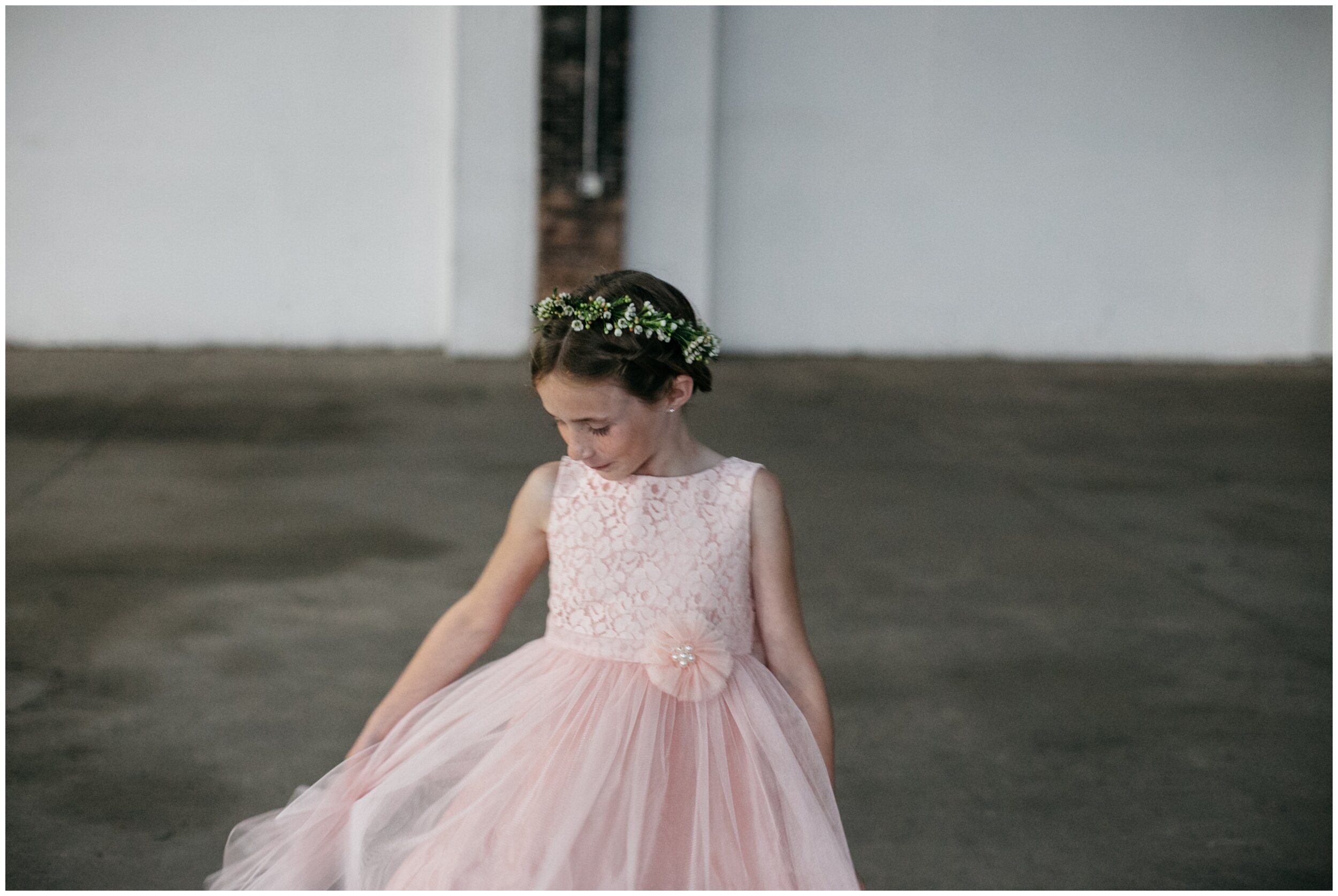 Flower girl playing with pink tulle dress