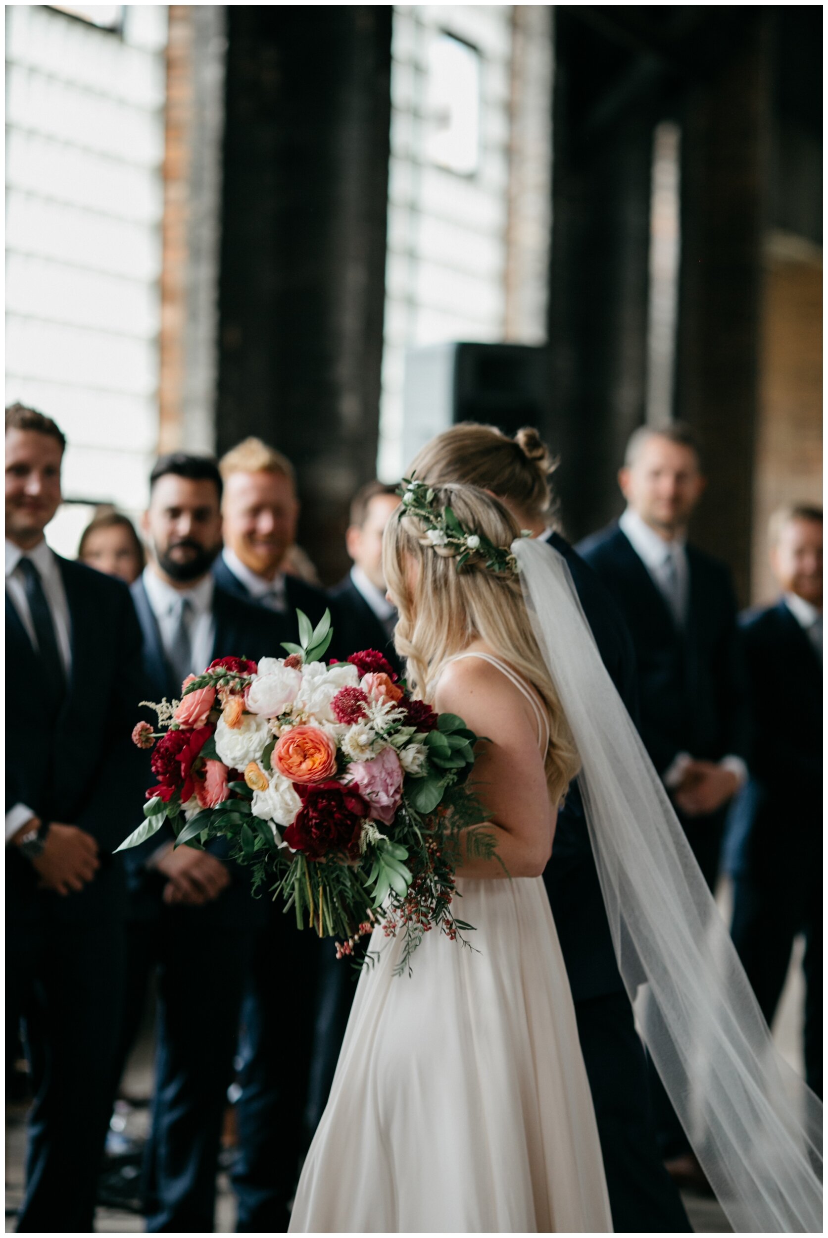 Bride walking down aisle in romantic industrial wedding venue at the Northern Pacific Center in Brainerd, Minnesota