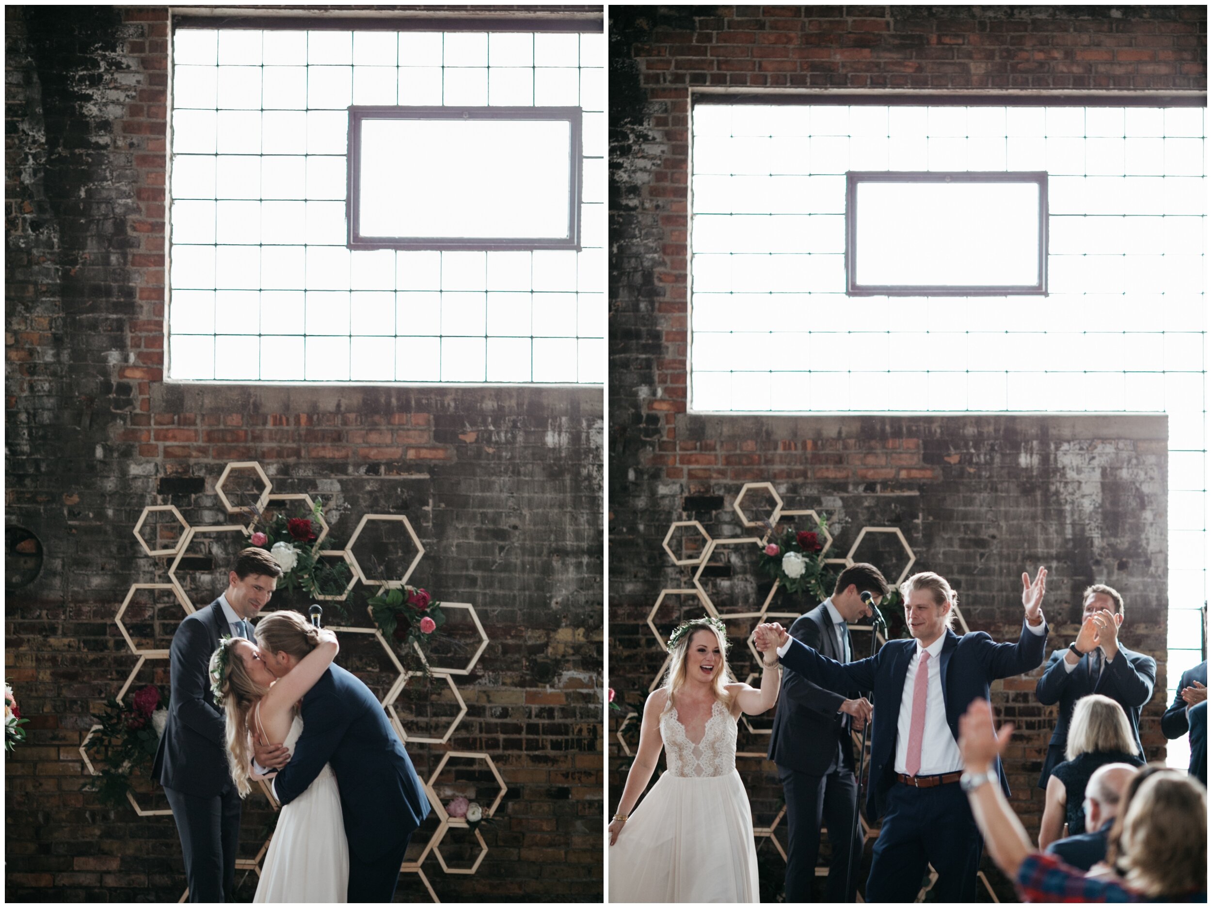 Bride and groom kiss during wedding in industrial warehouse