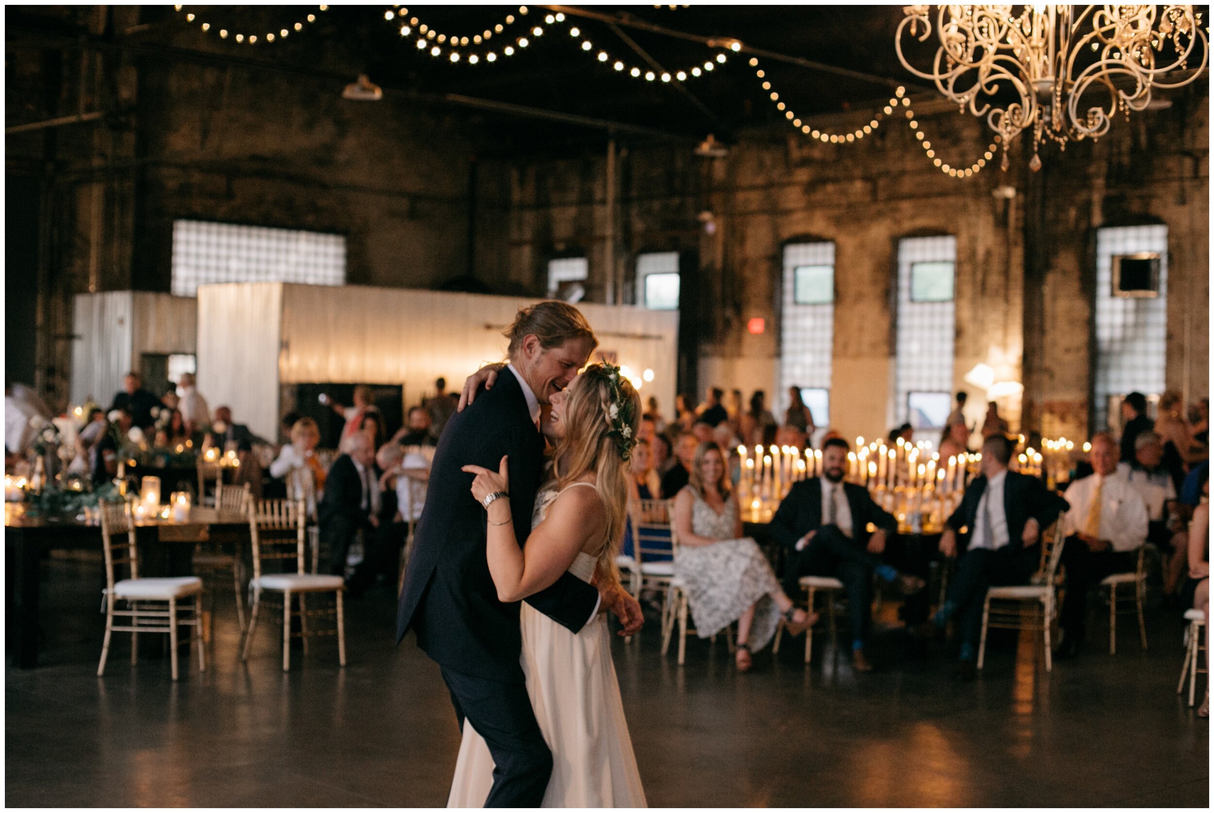 Bride and groom first dance in industrial warehouse wedding venue