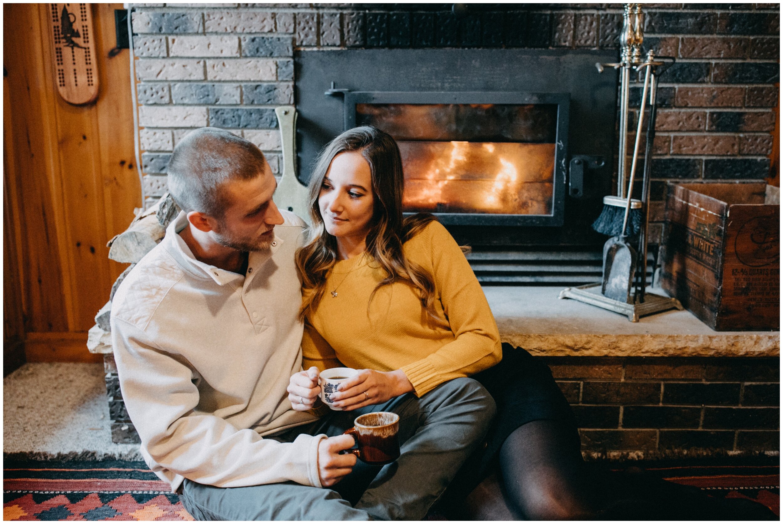 Romantic cabin engagement session by the fireplace