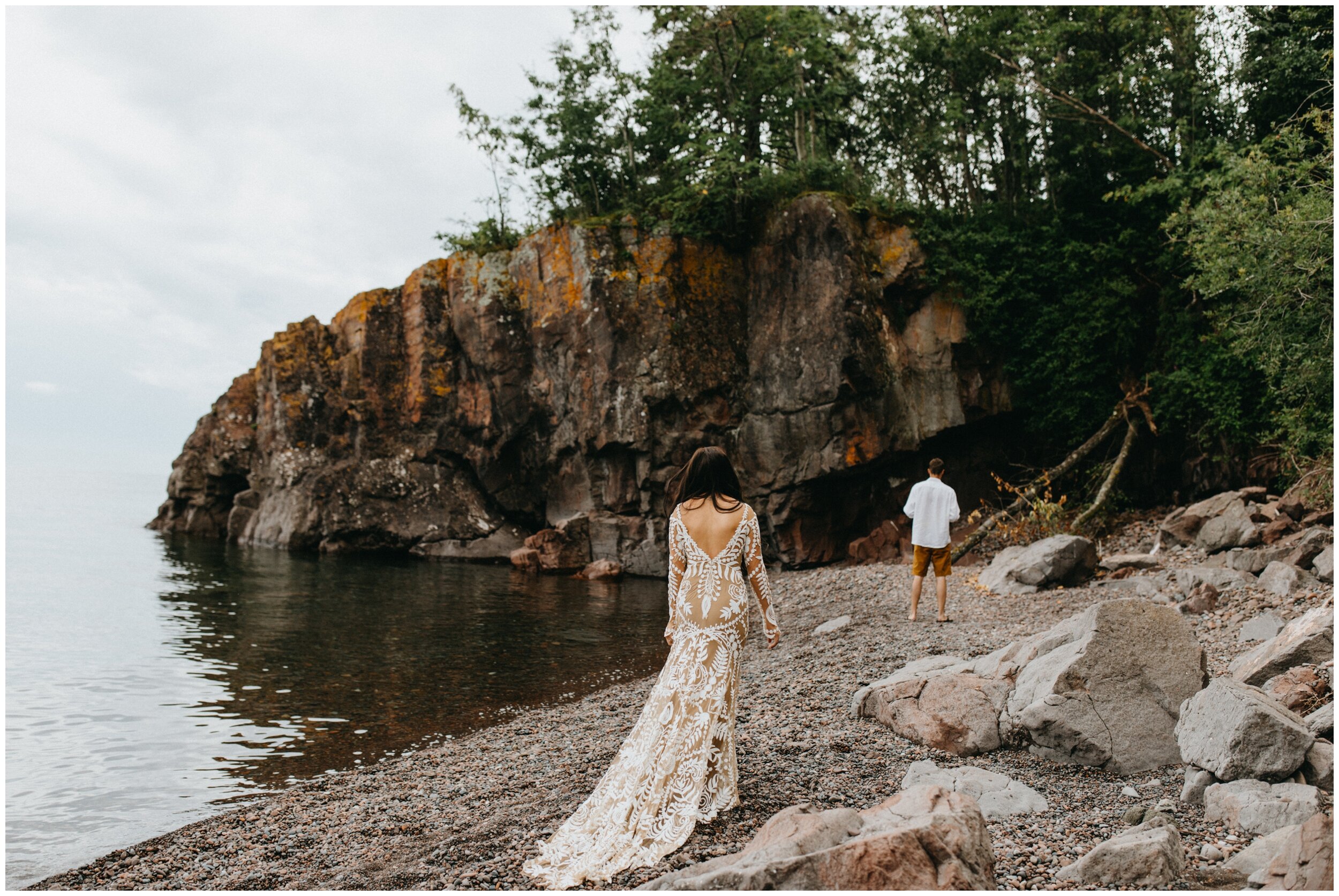 Bride and groom first look on the rocky beach at Lutsen Resort on Lake Superior