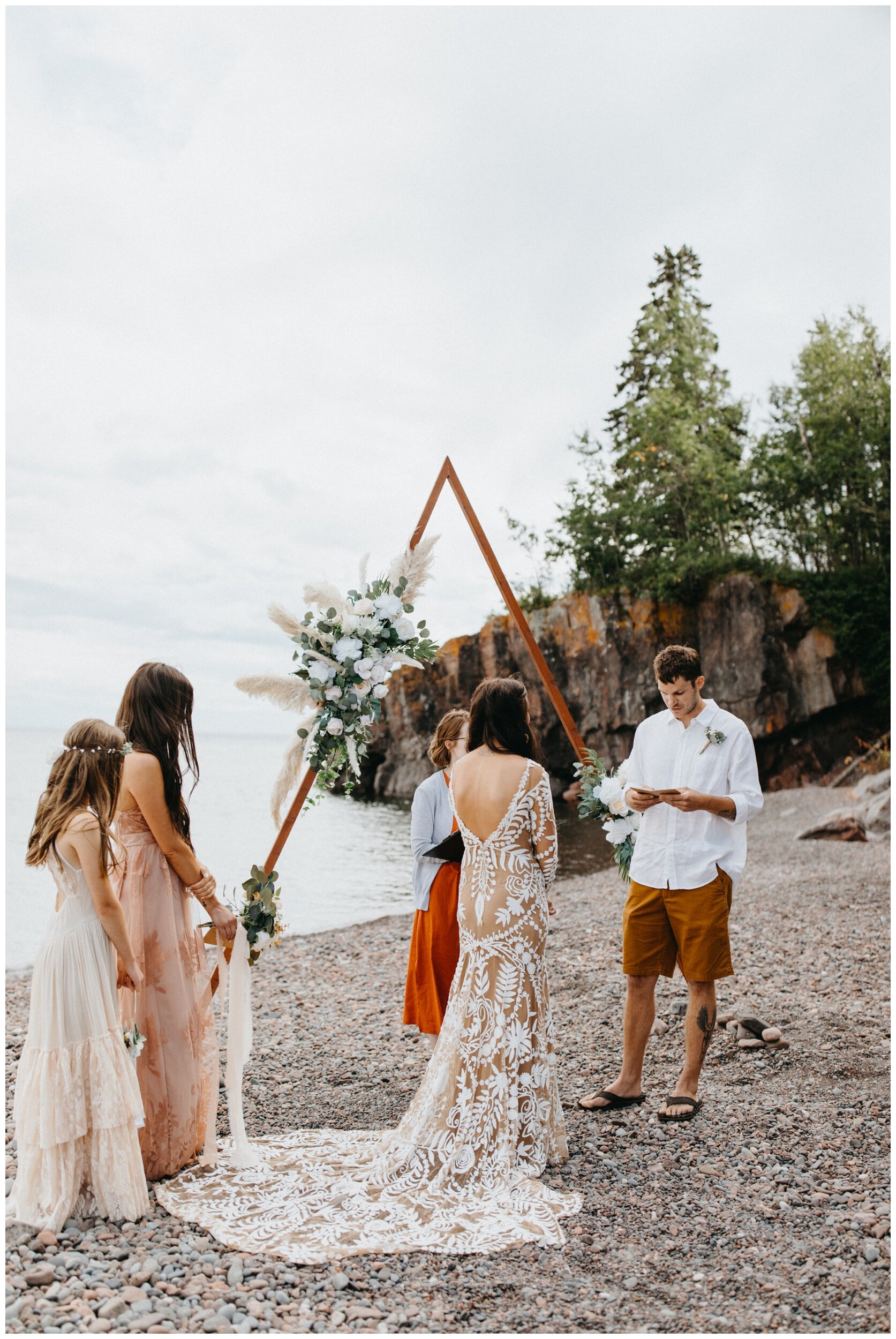 Groom saying vows during intimate beach wedding ceremony at Lutsen Resort