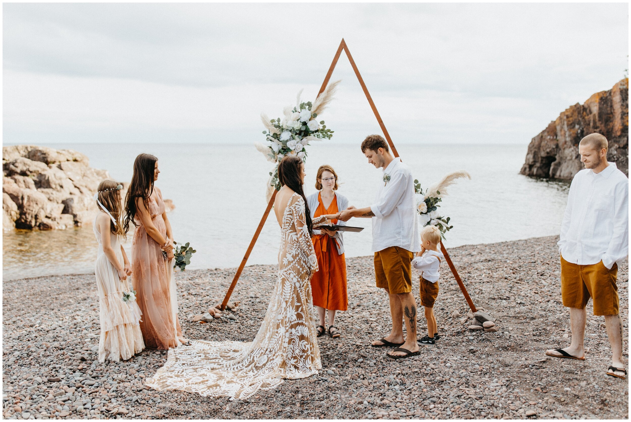 Bride and groom getting married on beach at Lutsen resort