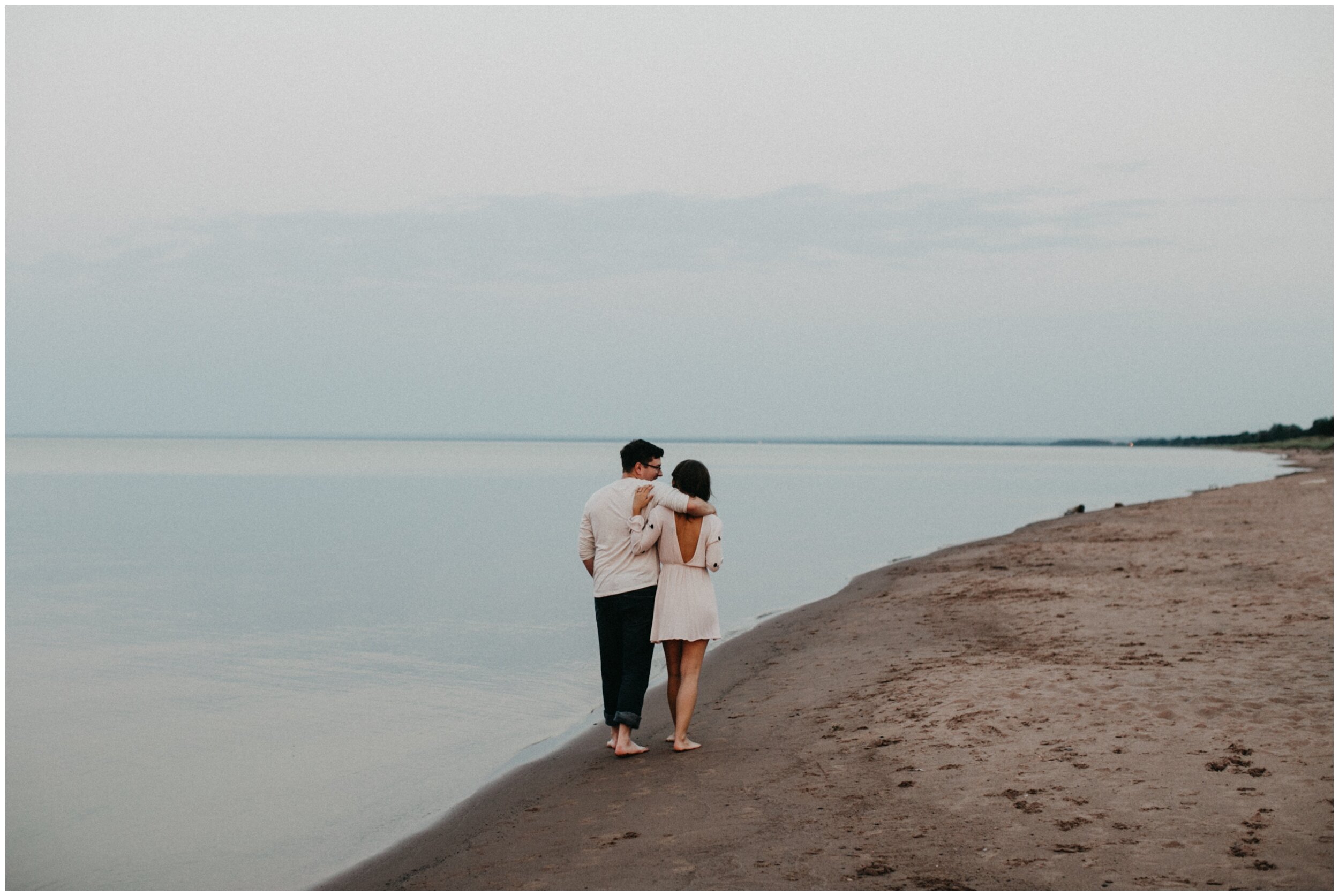 Couple walking along Lake Superior at Park Point beach in Duluth, Minnesota