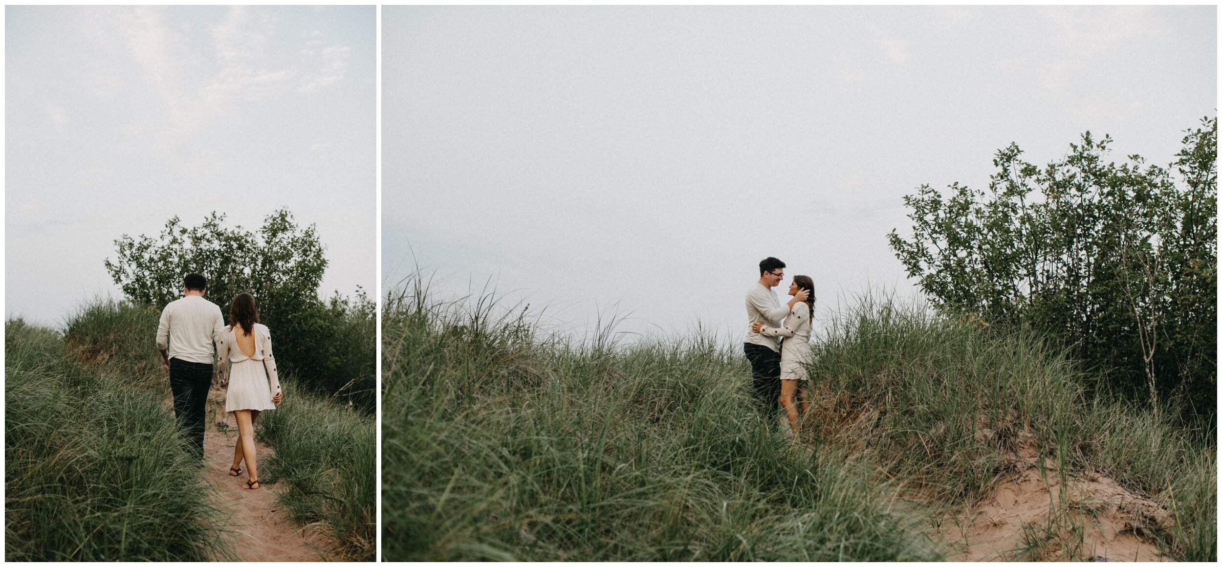 Couple standing on grassy sand dunes at park point beach in Duluth, Minnesota