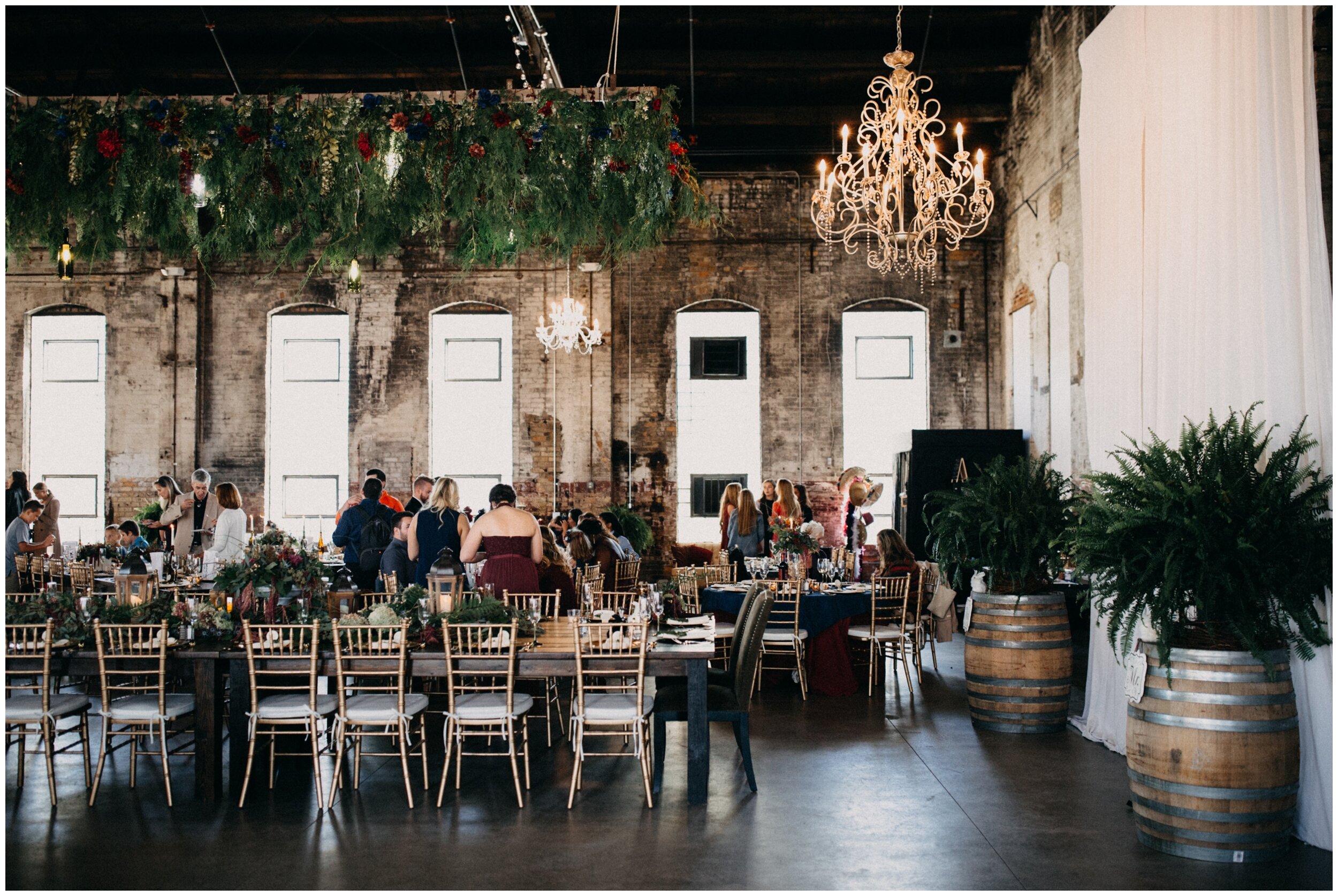 Floral chandelier and fern decor at Northern Pacific Center industrial warehouse wedding reception